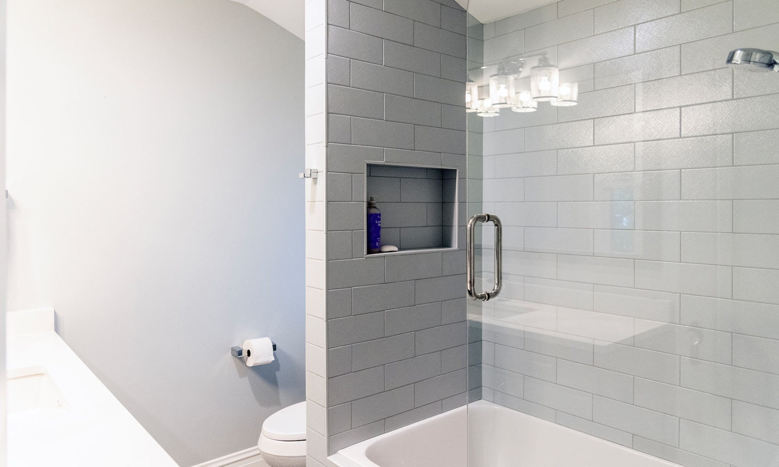 Newly renovated bathroom with white/gray tile in the shower
