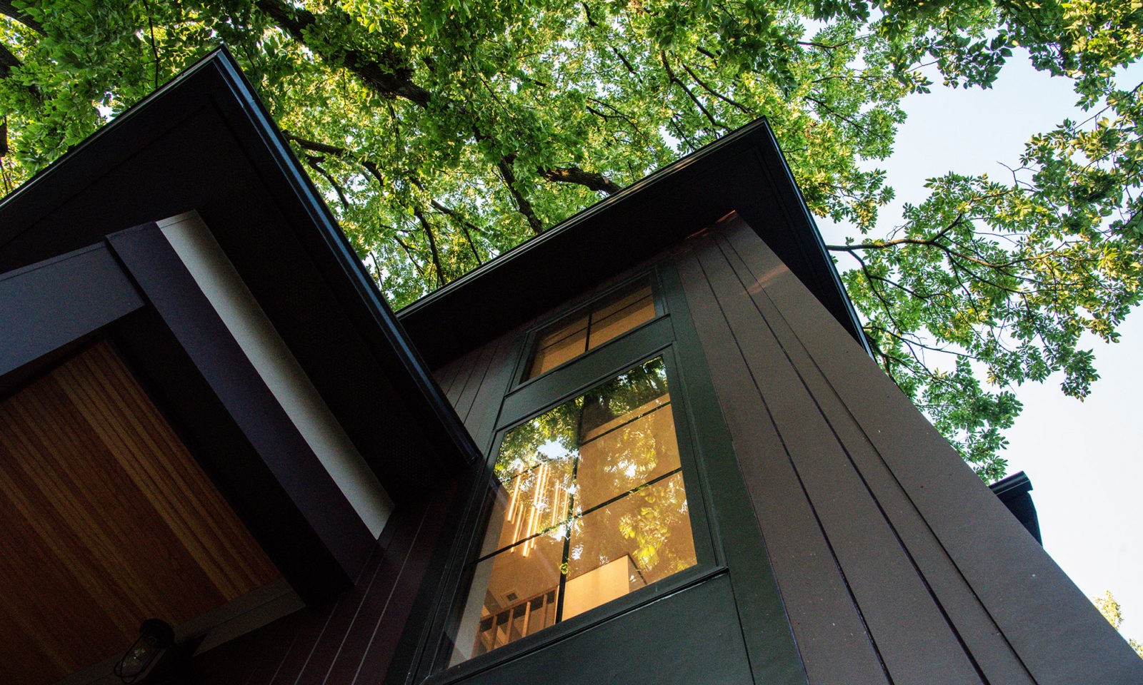 Exterior image of a home looking up into a well lit window