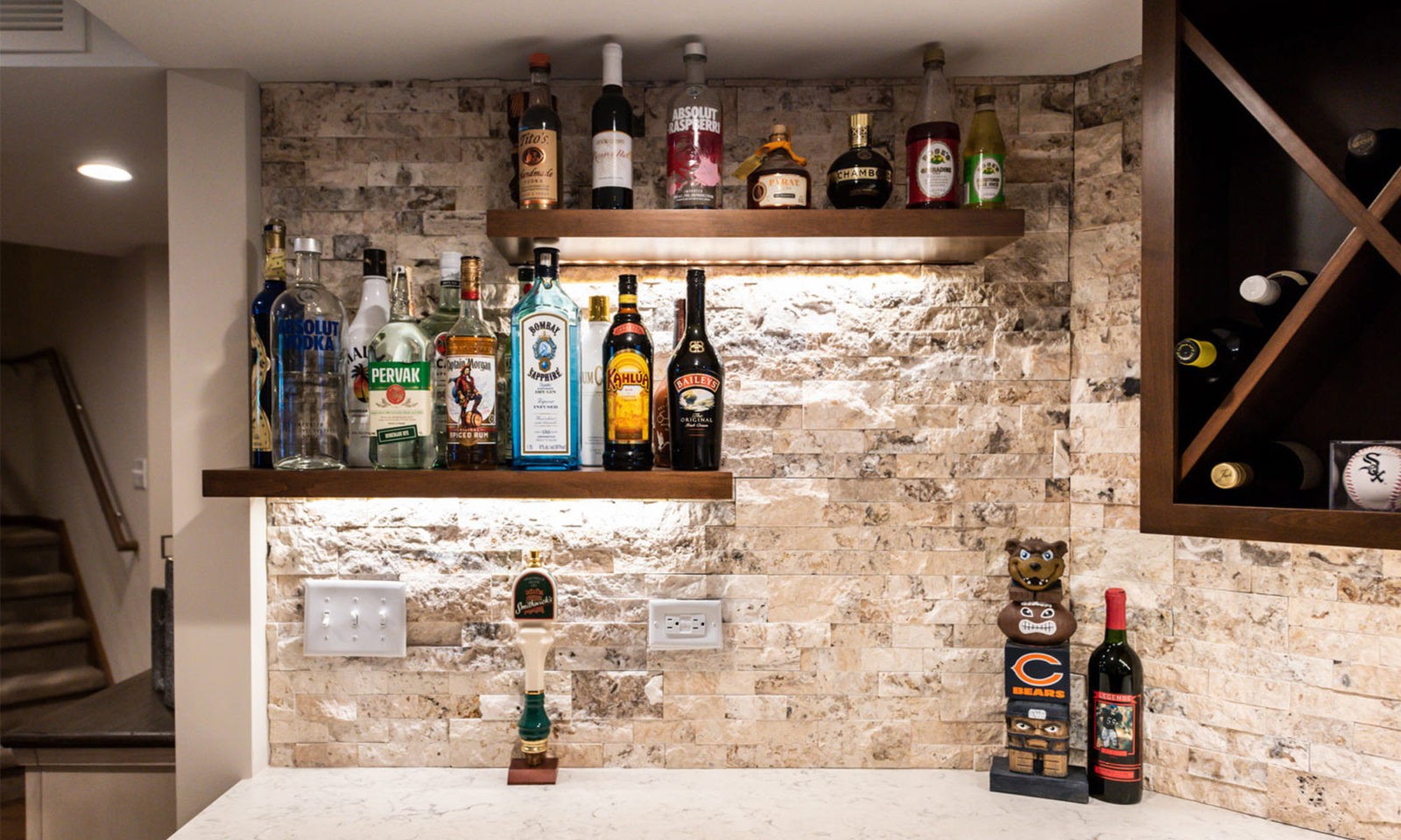 view of basement remodel bar with sports game on TV