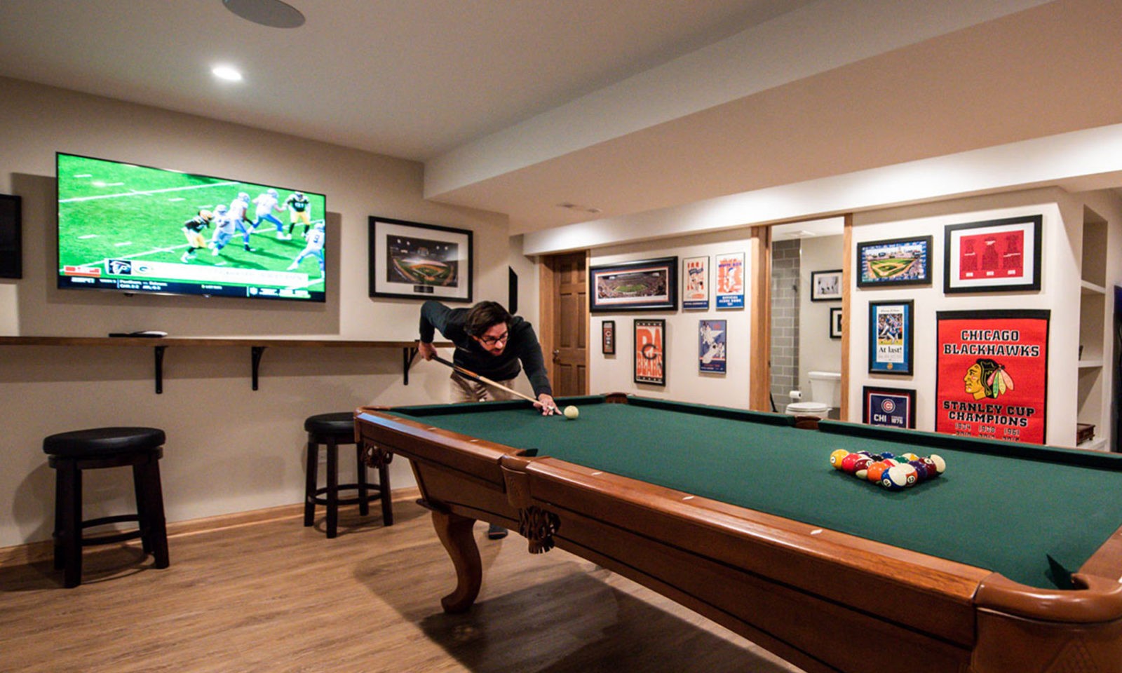 view of basement remodel game and pool table area with man playing pool