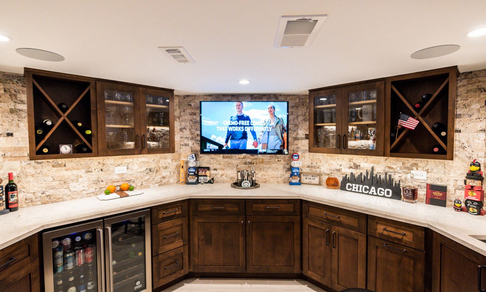 view of basement remodel bar with sports game on TV