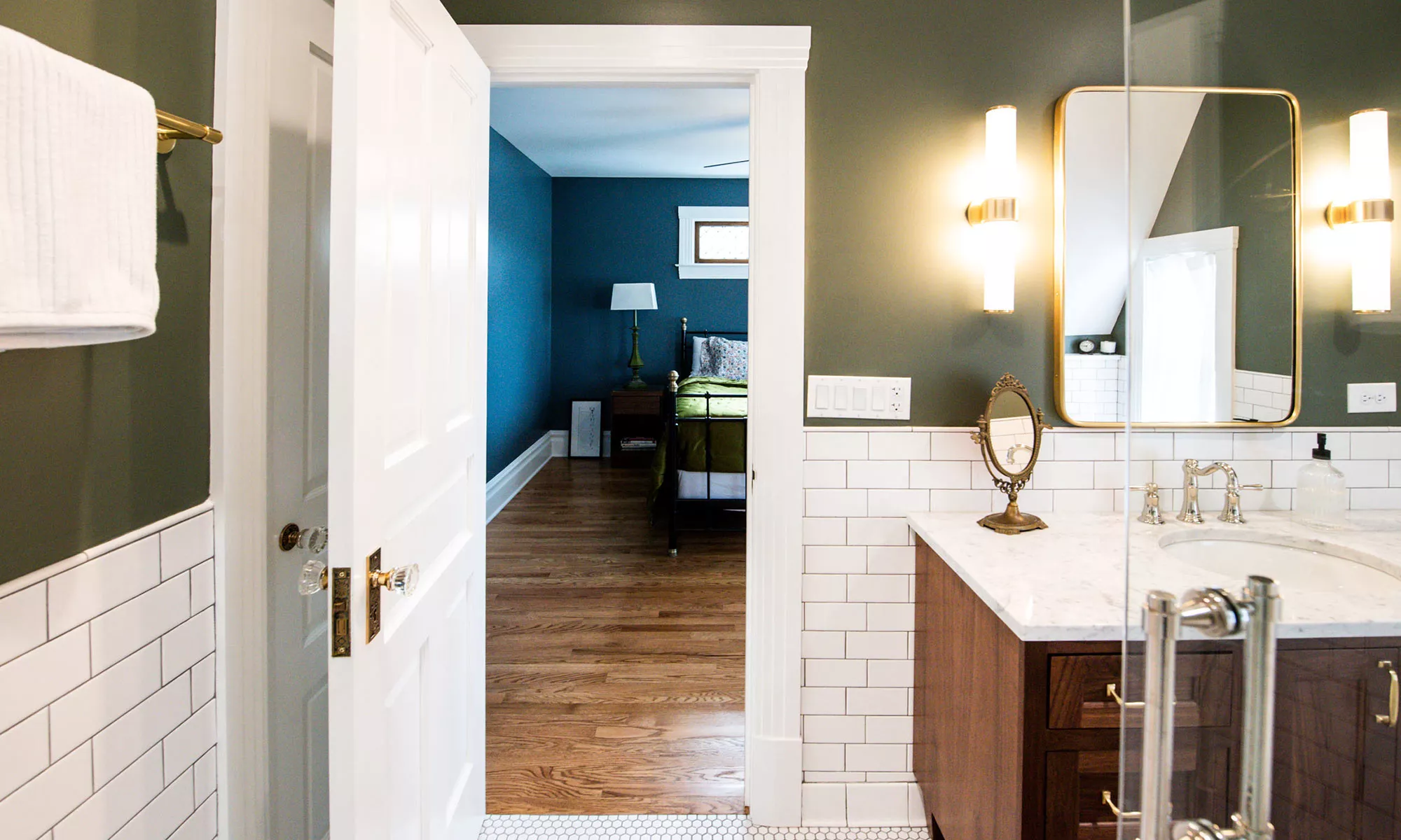 luxury bathroom with walnut vanity and gold fixtures