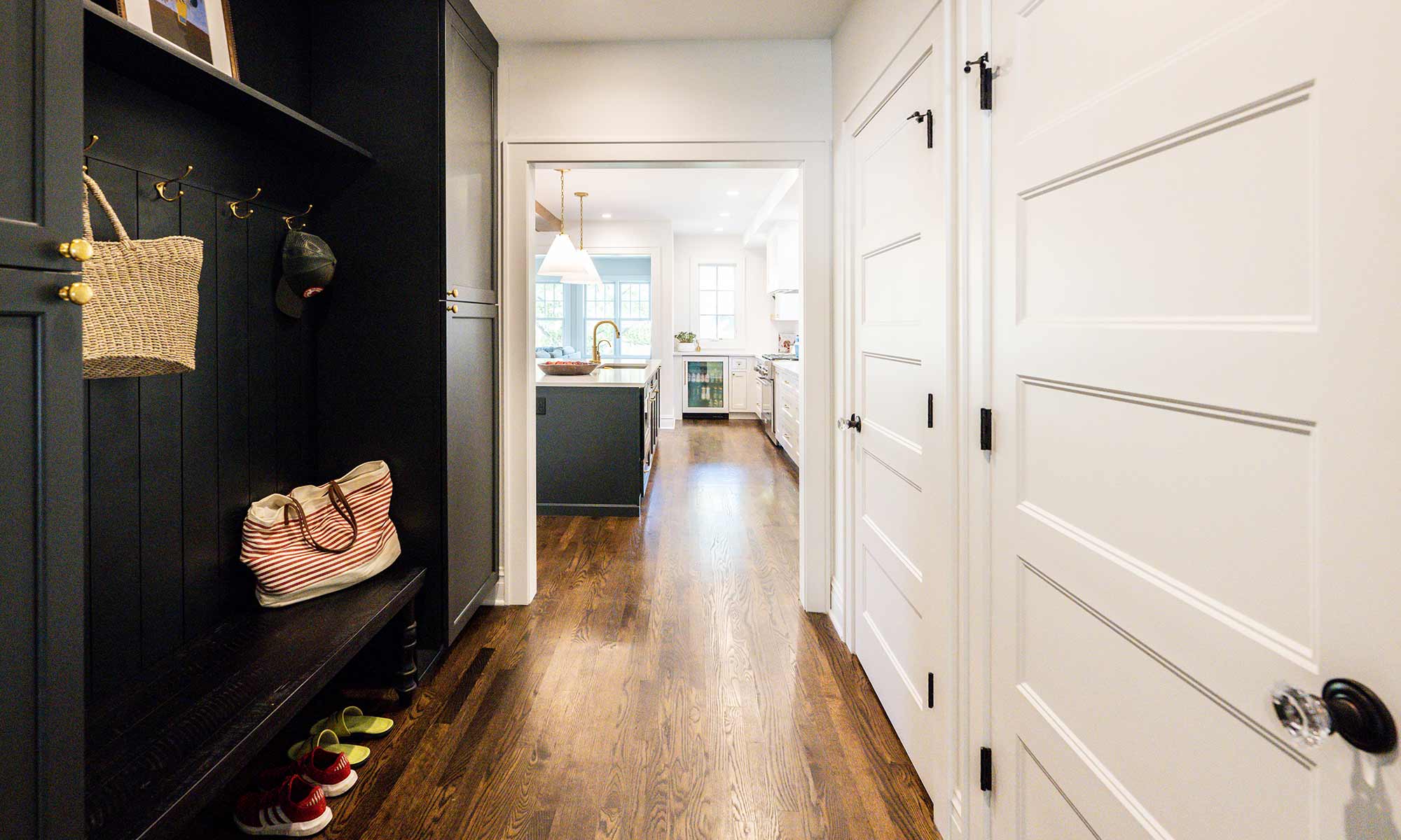 view of luxury remodel mudroom and hallway with dark grey cabinets