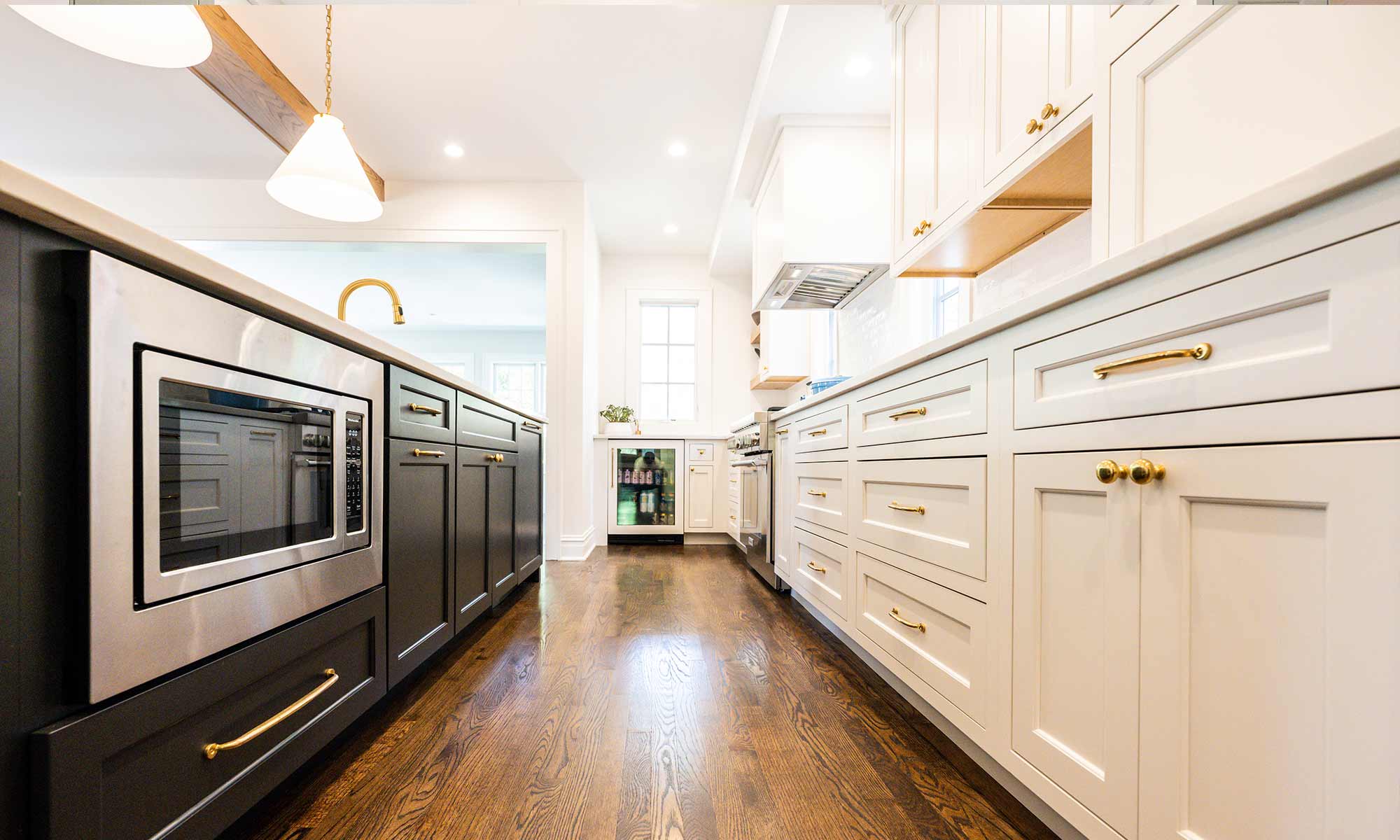 Luxury remodel and kitchen island with white and blue cabinets and white quartz countertops