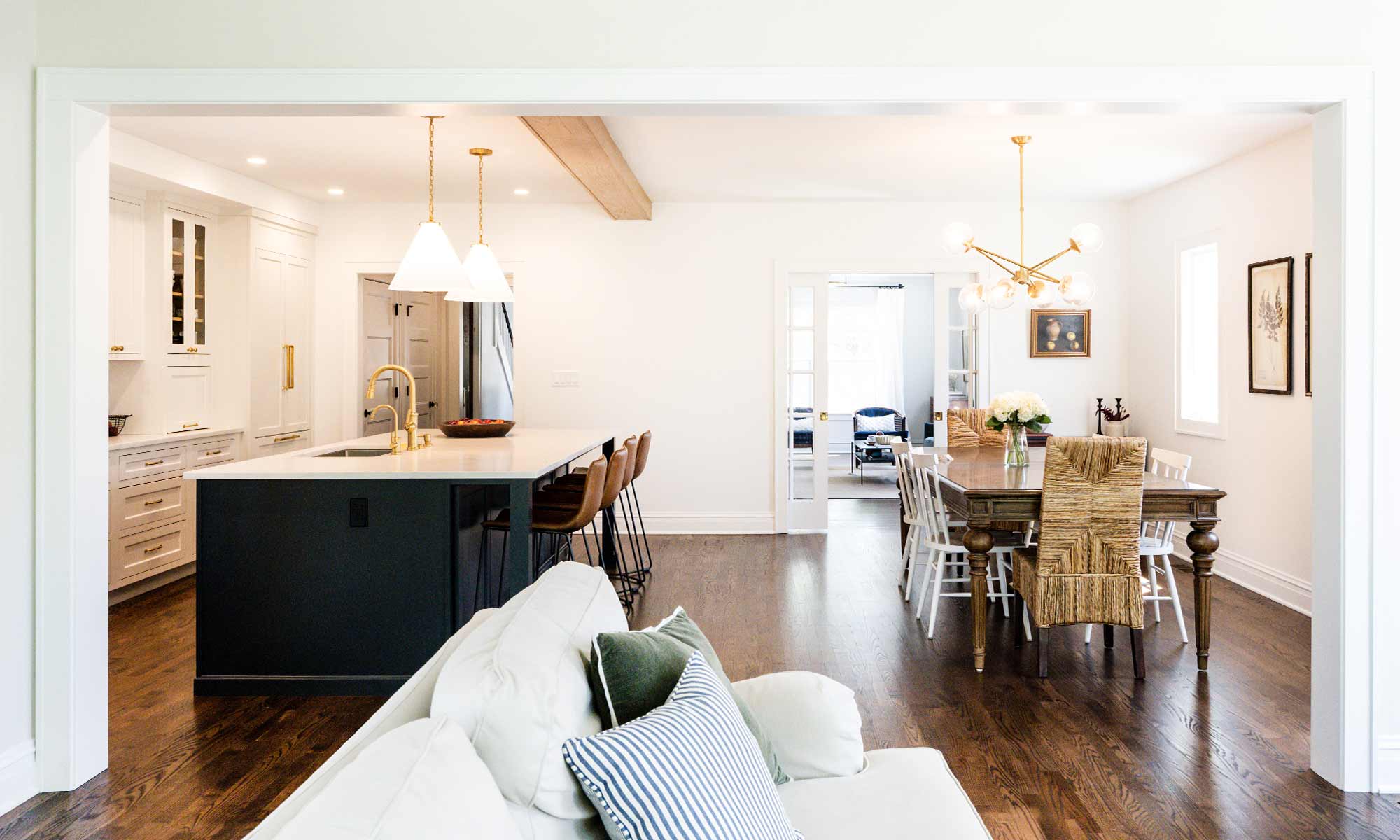 Luxury remodel and kitchen island with white and blue cabinets and white quartz countertops