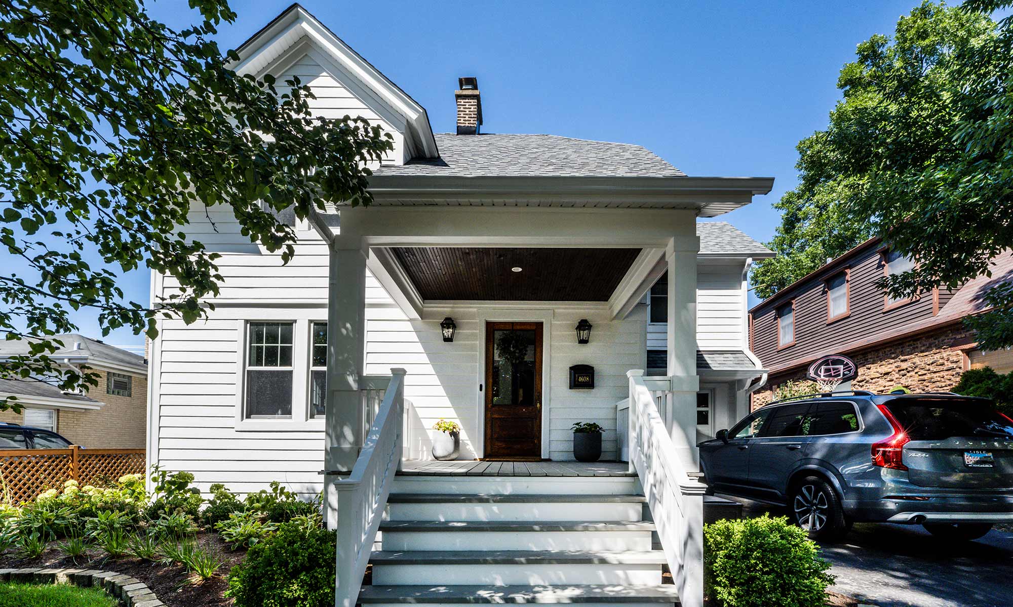 exterior photo of white home with open front porch in Chicago's western suburbs