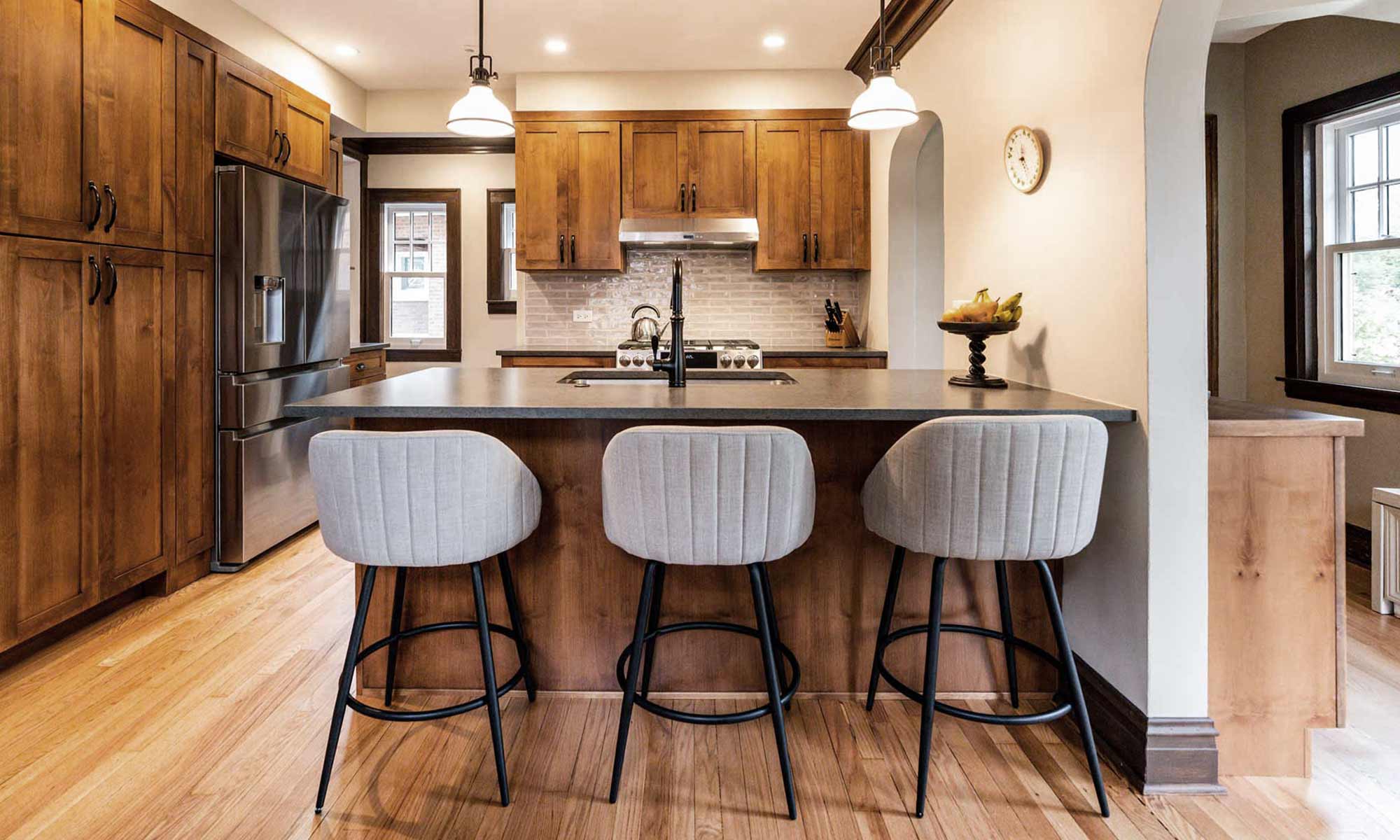 kitchen remodel from livcompanies wood cabinetry three grey barstools 2 pendants recess lighting