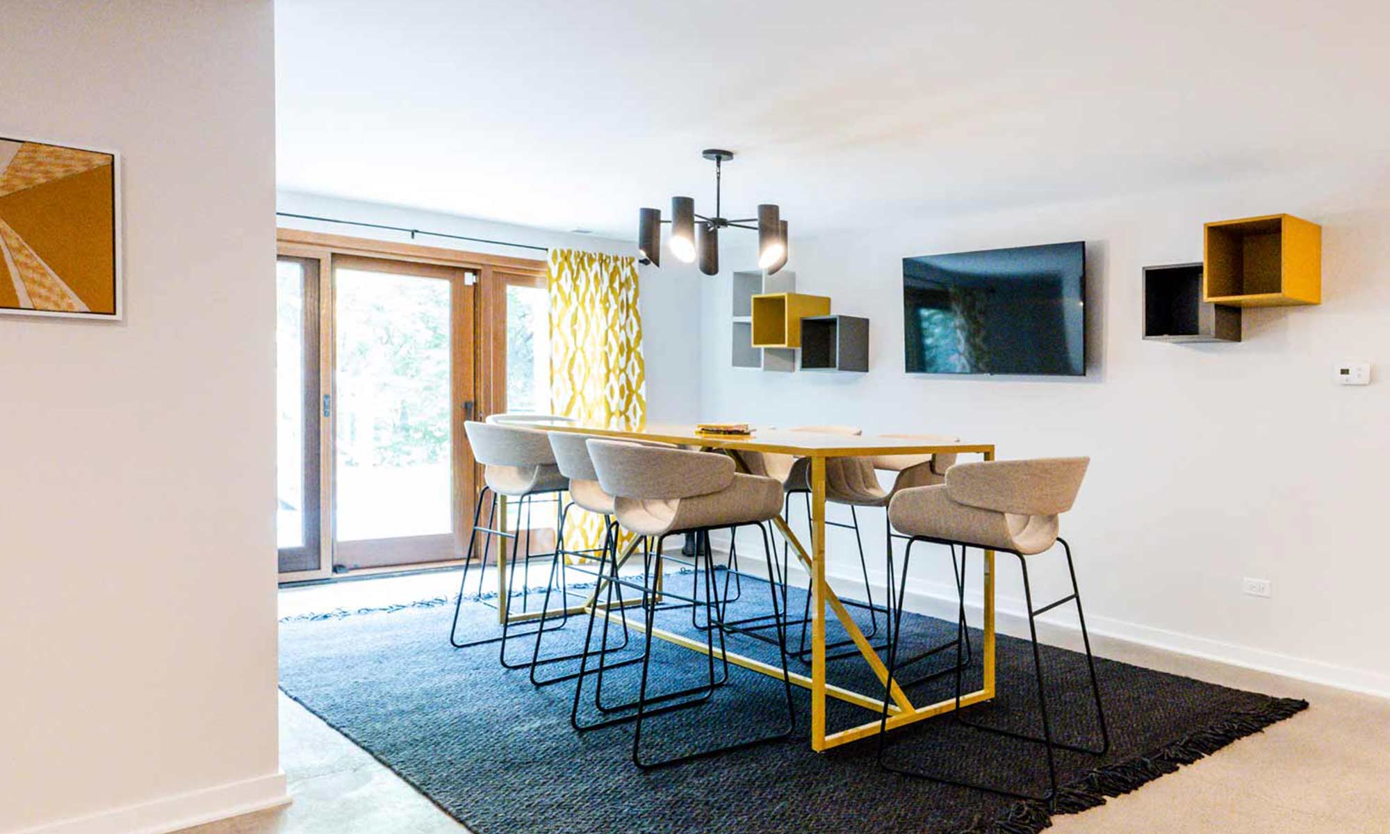 yellow table and tall chairs in luxury basement remodel