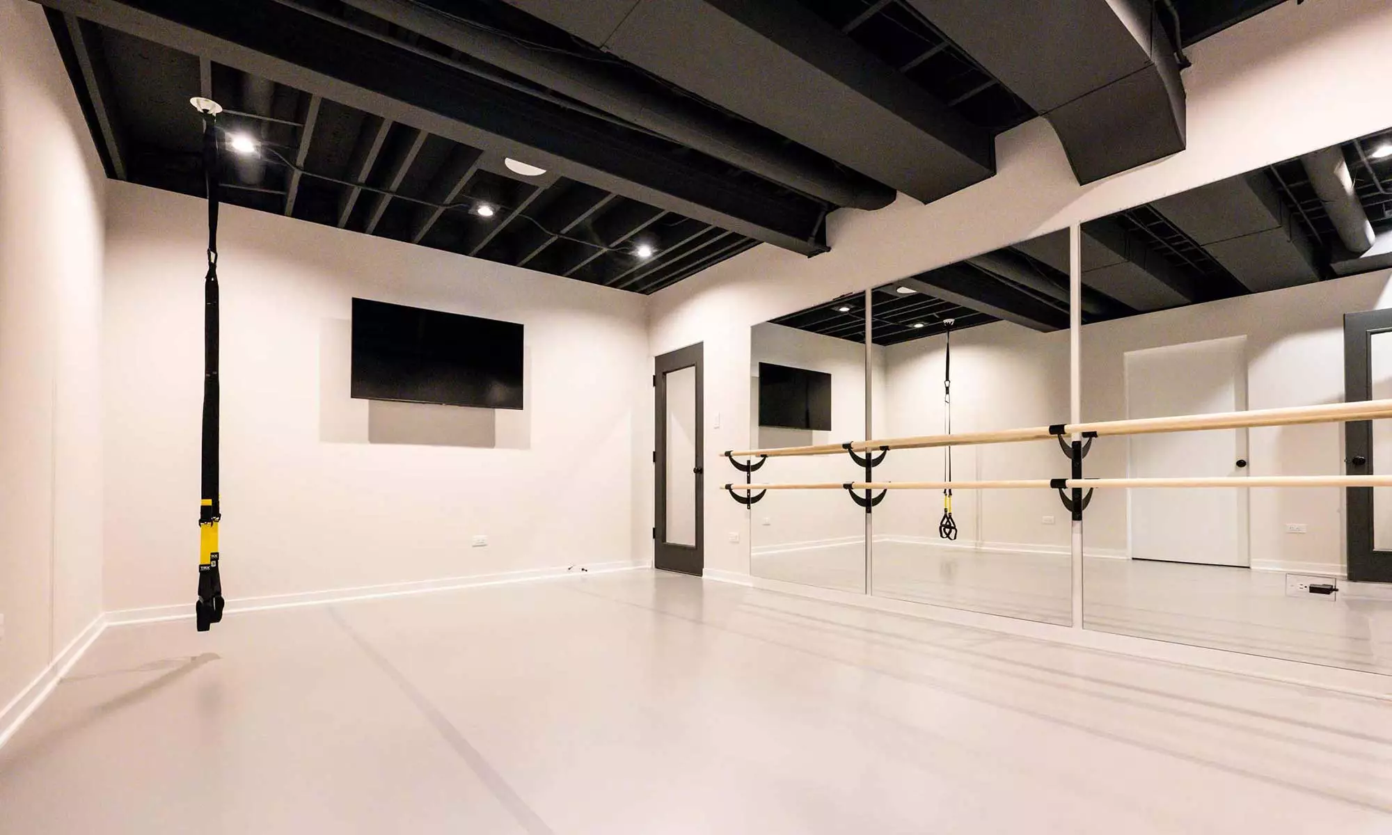 dance studio with mirror wall in luxury basement remodel