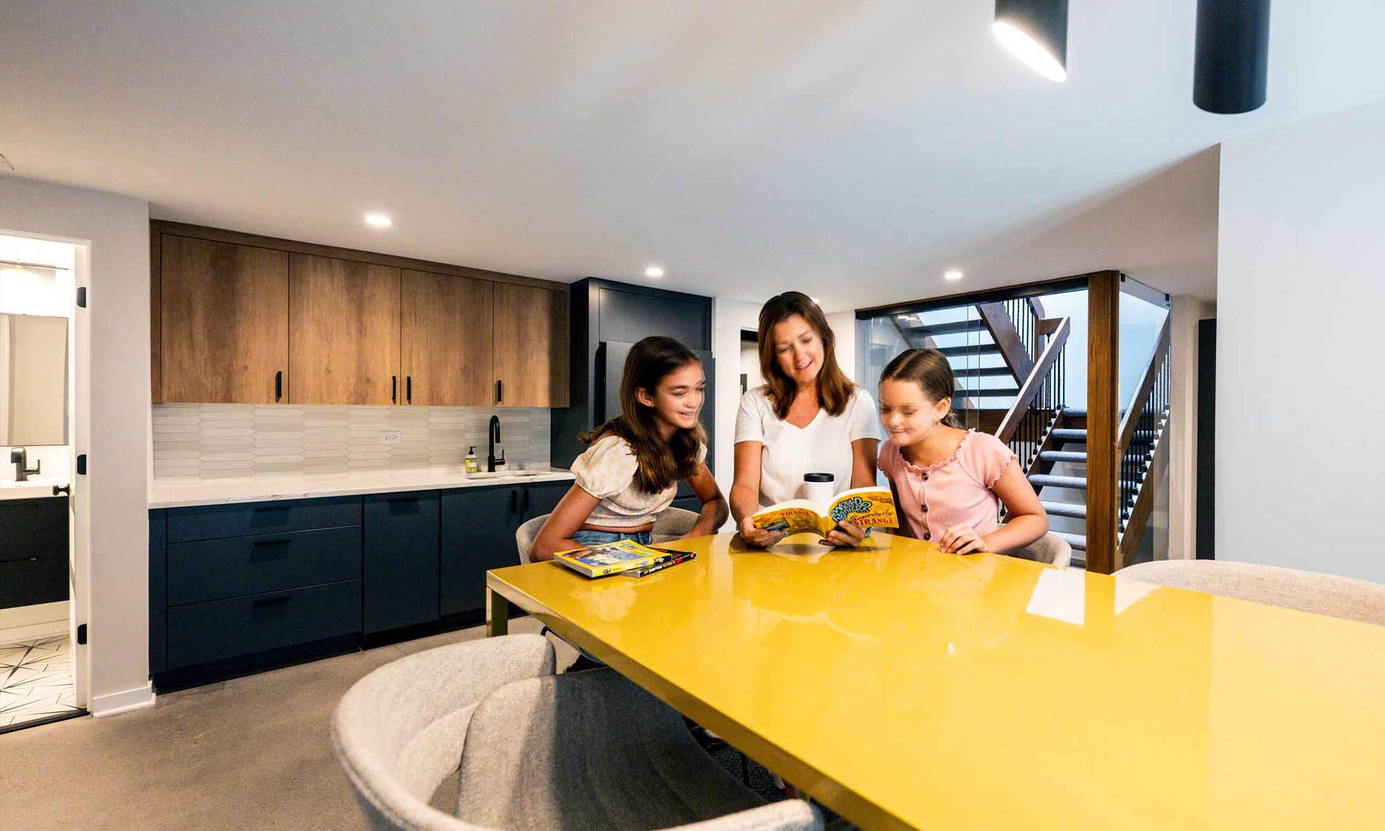 family gathered around a tall table in luxury basement remodel