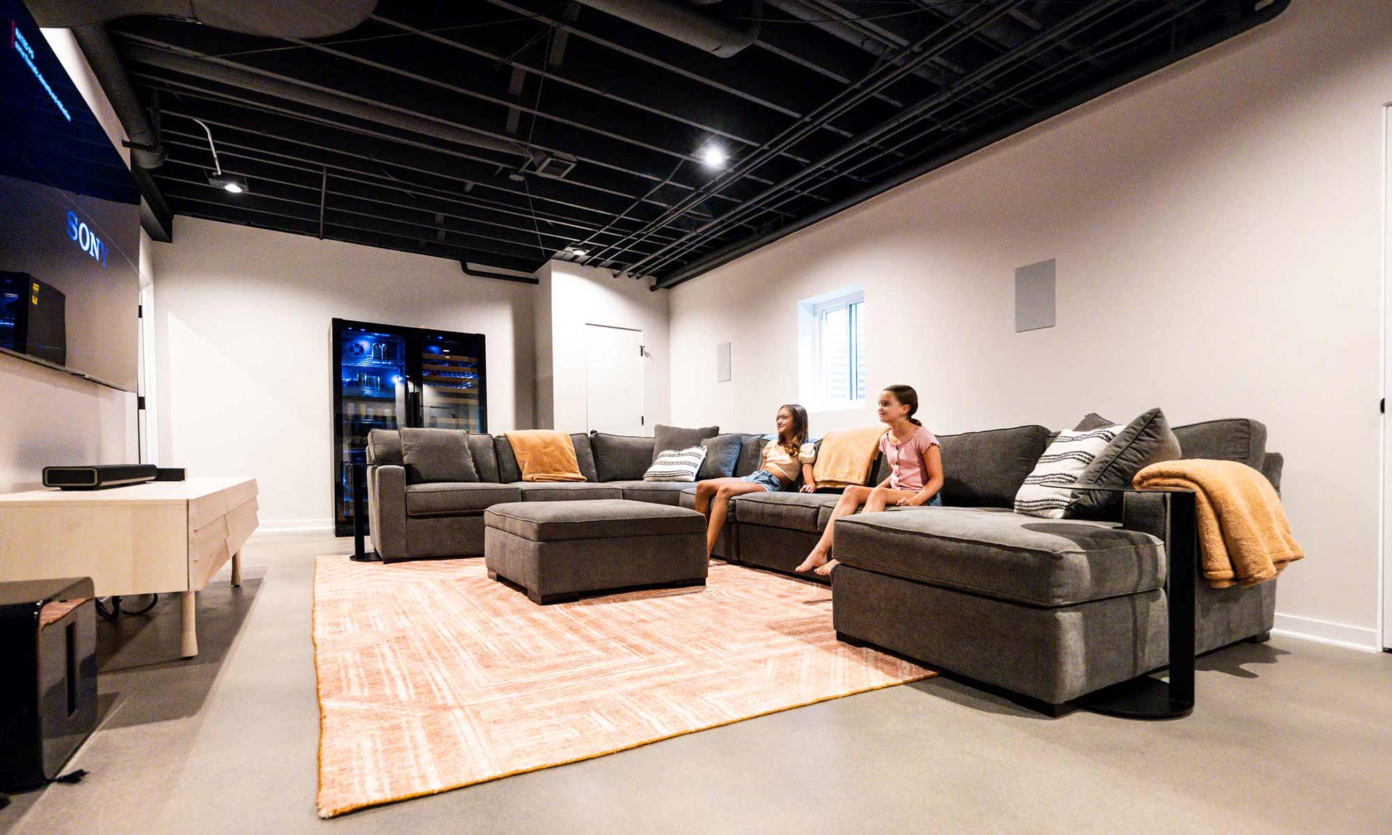 Basement remodel with a wine fridge and living room