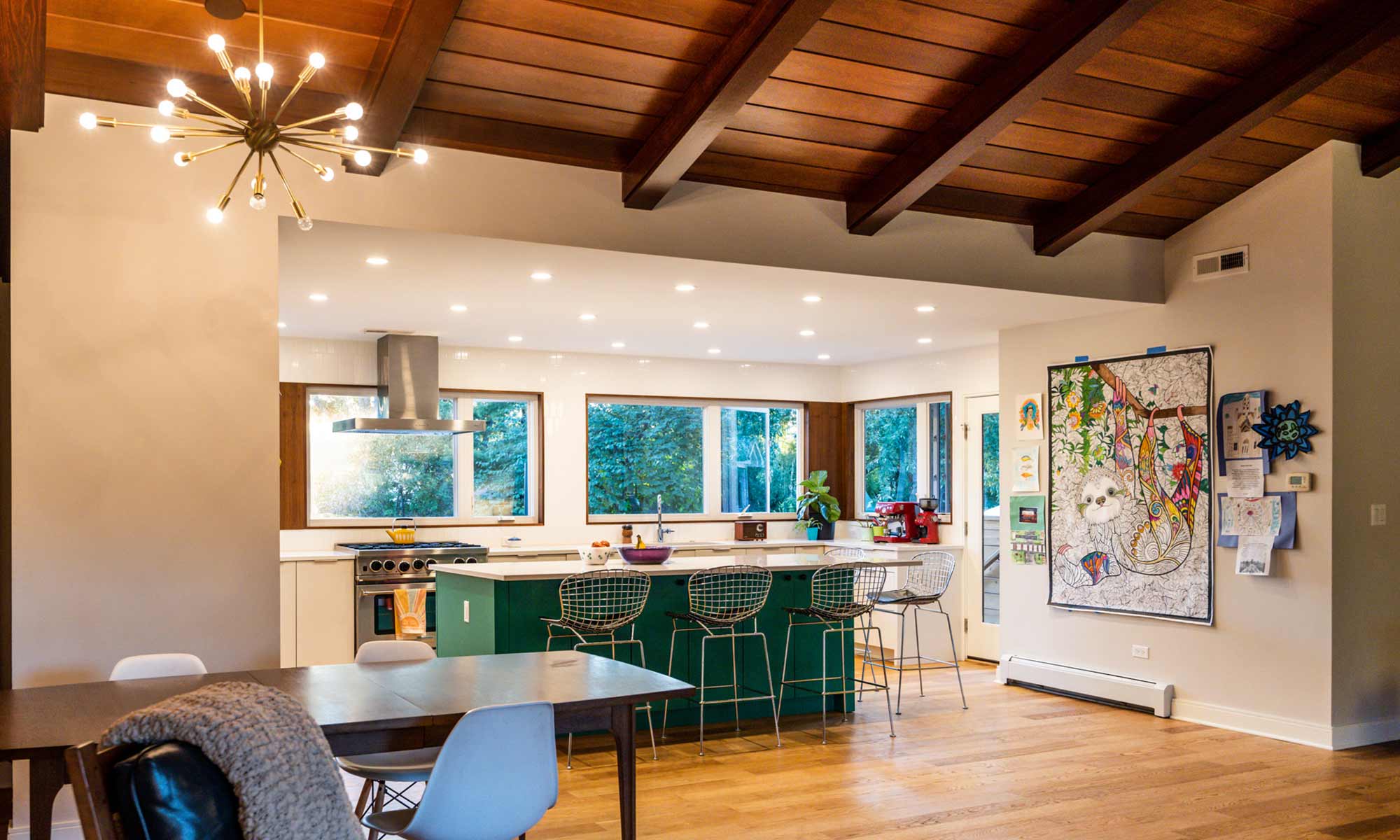 home renovation exposed beams in living room recess lighting in kitchen large green island