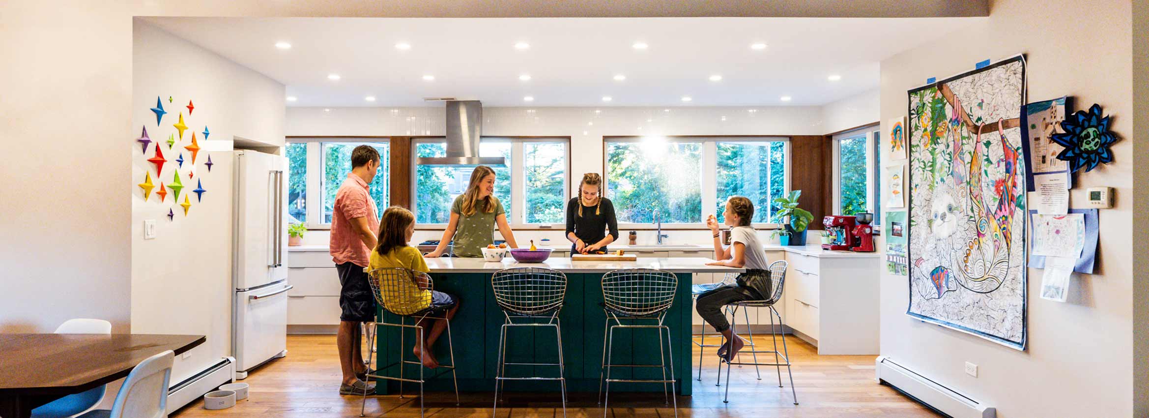 family gathered in modern kitchen addition