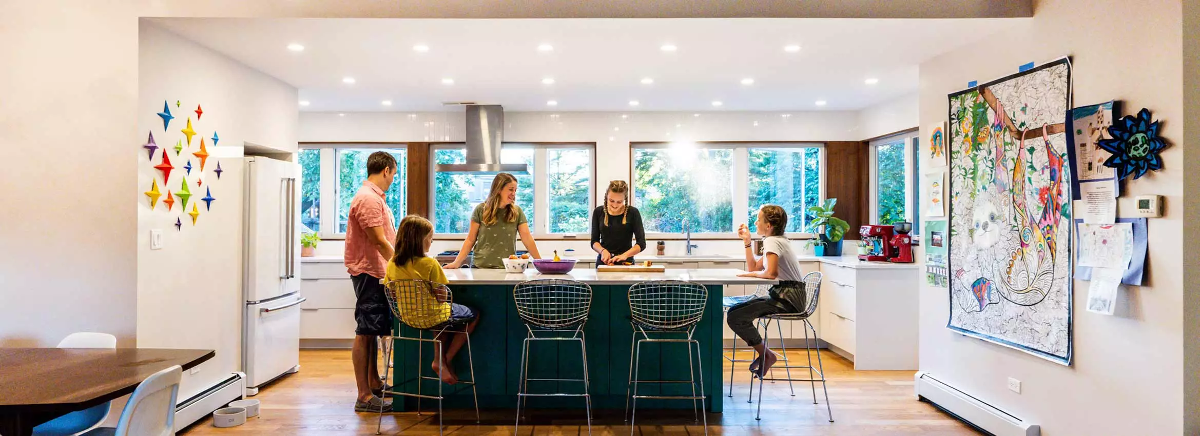 family gathered in modern kitchen addition