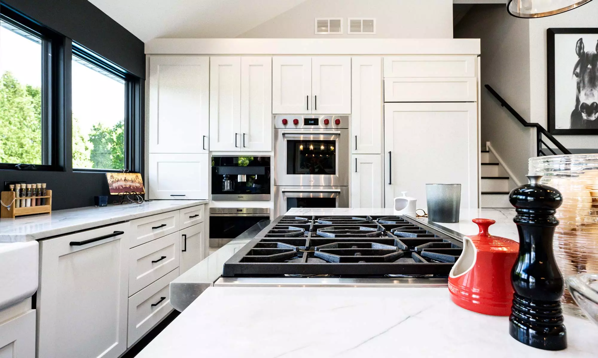 luxury kitchen view with white cabinets builtin appliances and island range