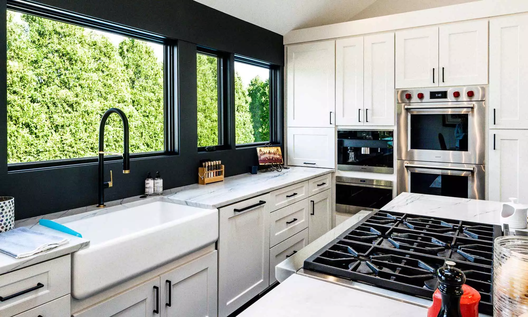 luxury kitchen remodel with blue island and windows to the backyard pool