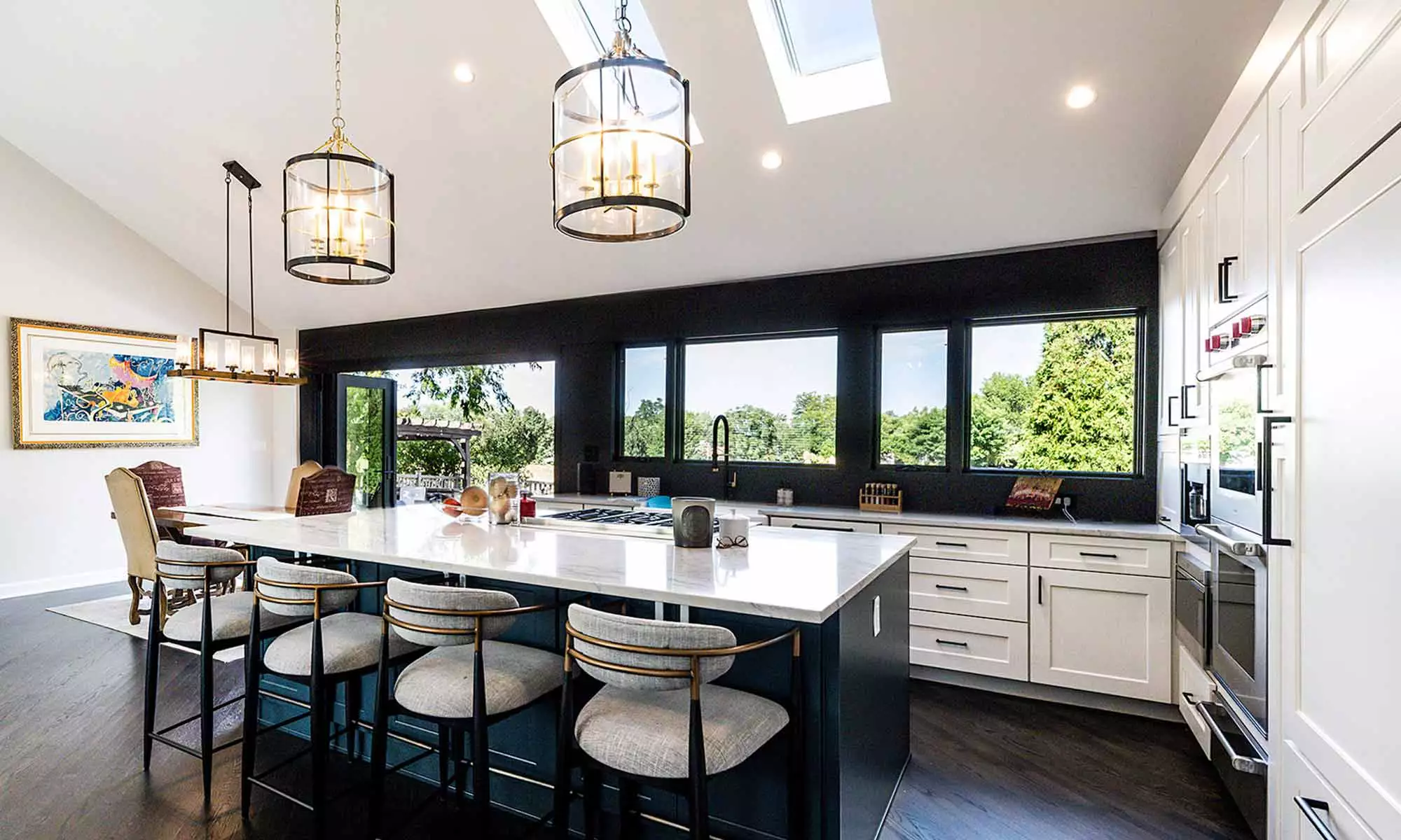 luxury kitchen remodel with blue island and windows to the backyard pool