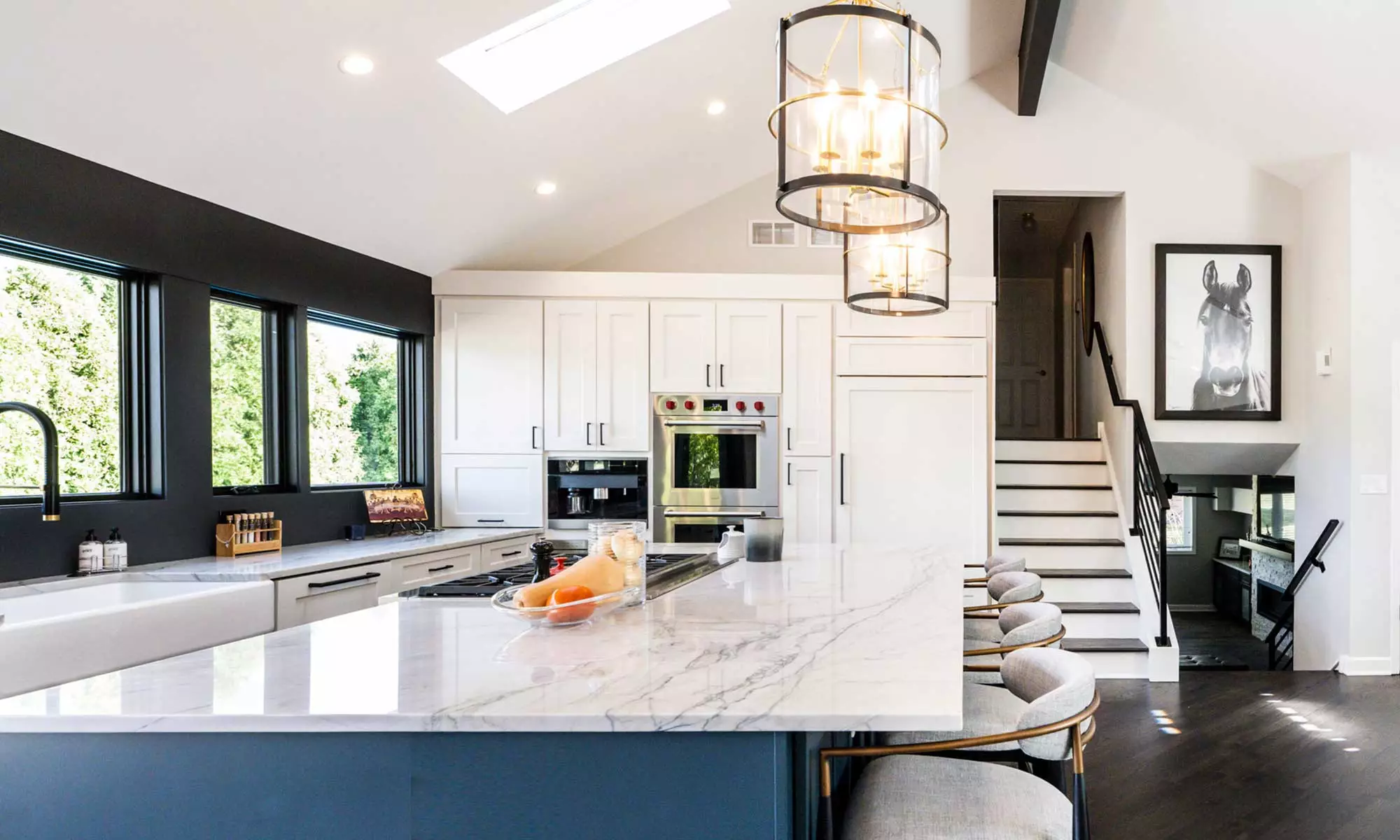 luxury kitchen remodel with blue island and windows to the backyard pool