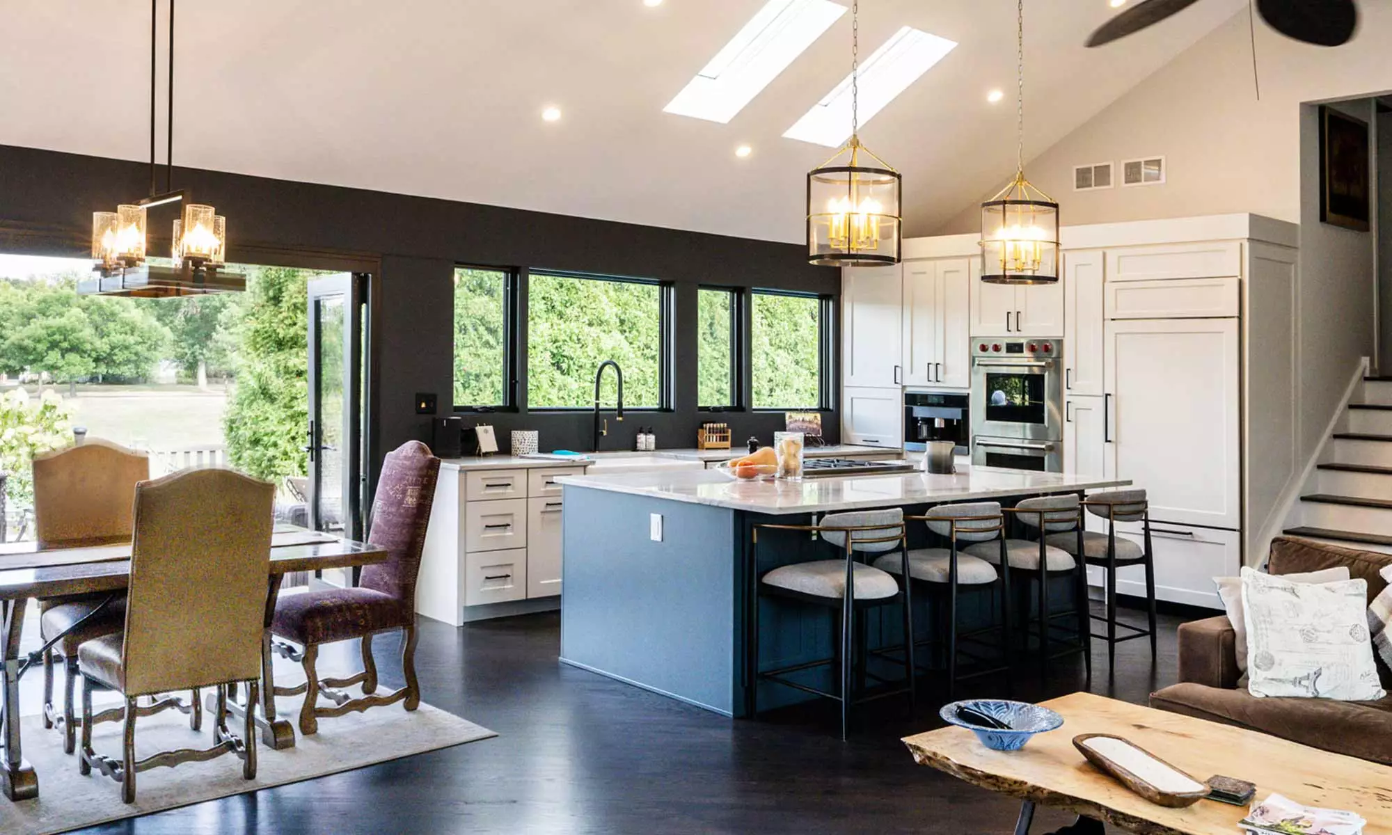 luxury kitchen remodel with blue island and windows to the backyard pool