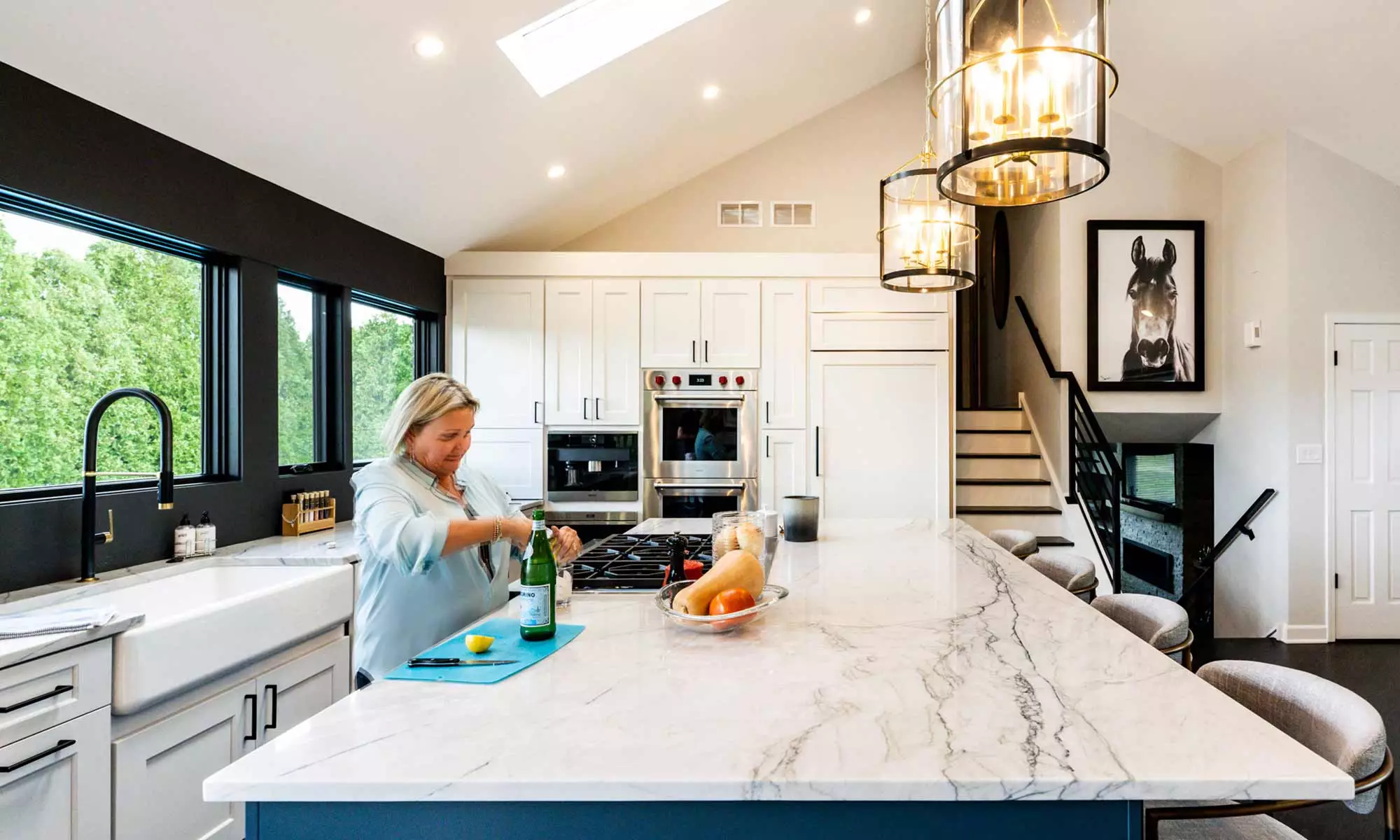woman working at kitchen island in luxury remodel
