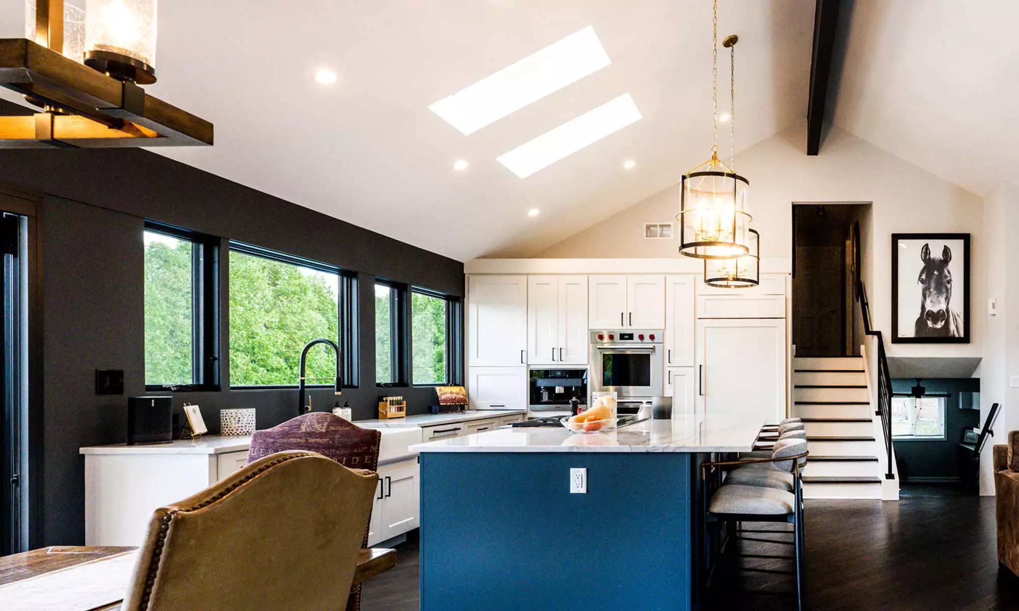 luxury kitchen remodel with blue island and windows to the backyard pool