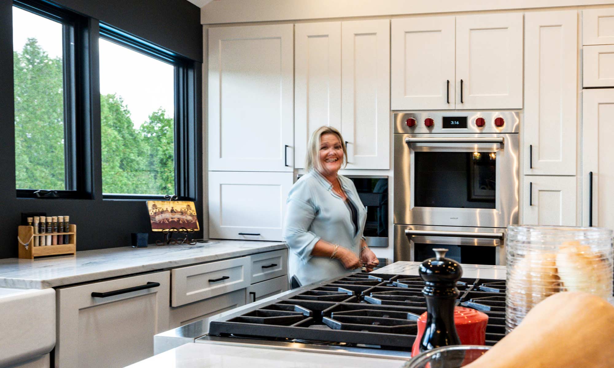 woman working at kitchen island in luxury remodel