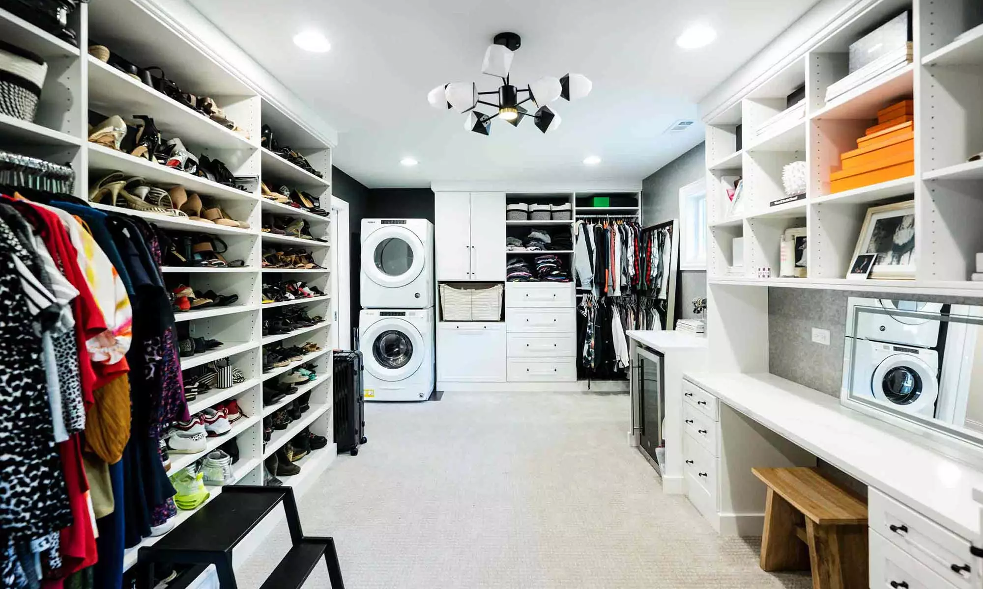 built-in makeup desk in large luxury closet with washer dryer