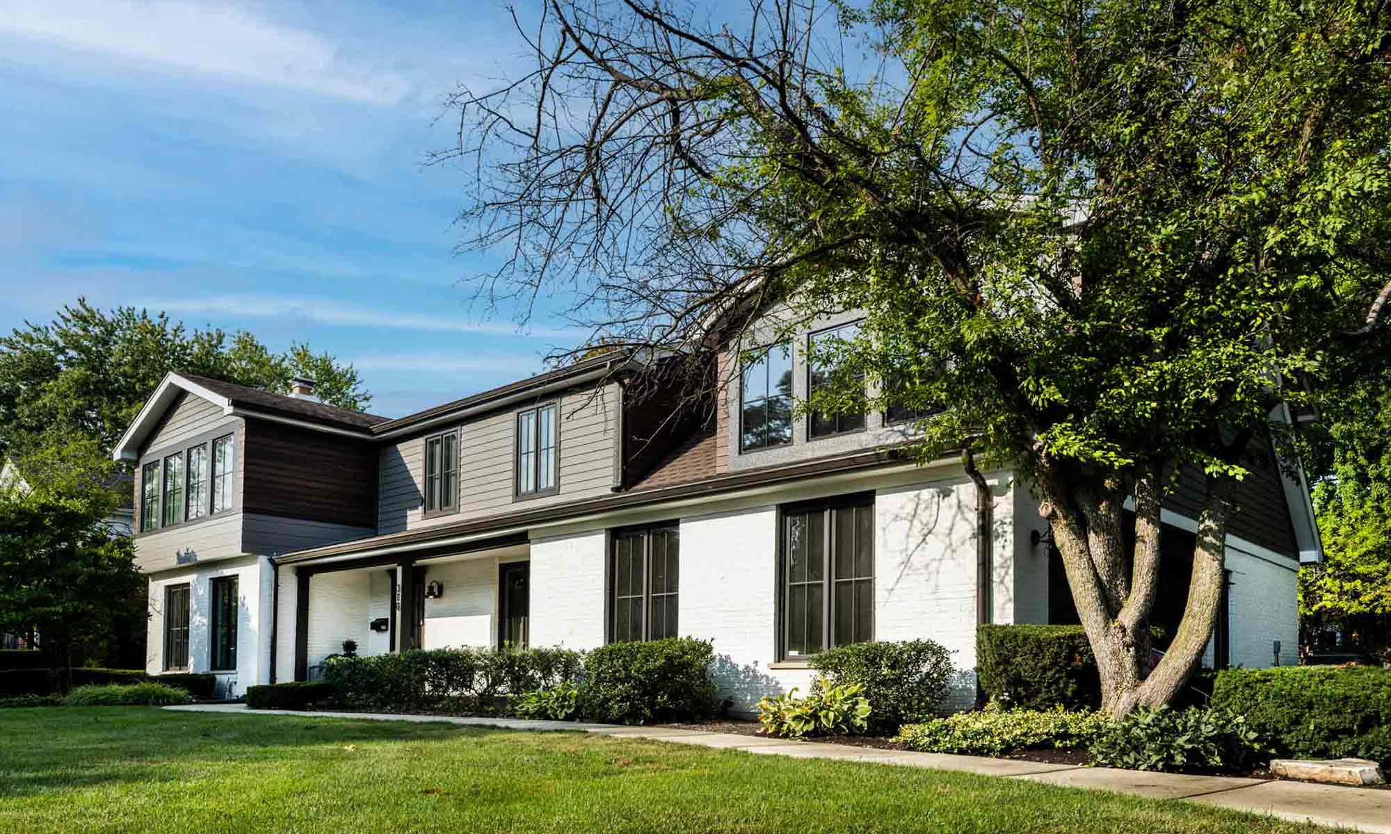 exterior view of primary suite addition with gray and wood siding