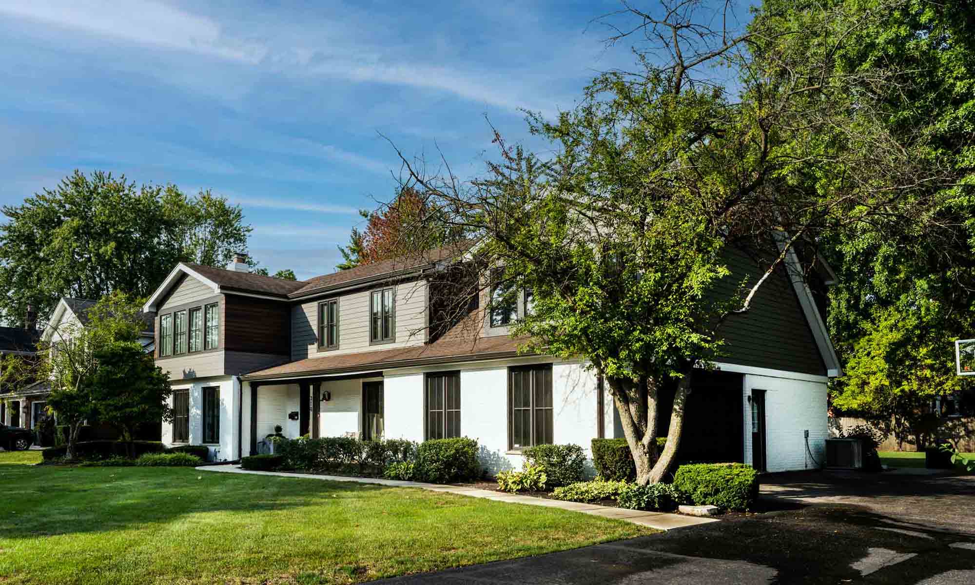 exterior view of primary suite addition with gray and wood siding