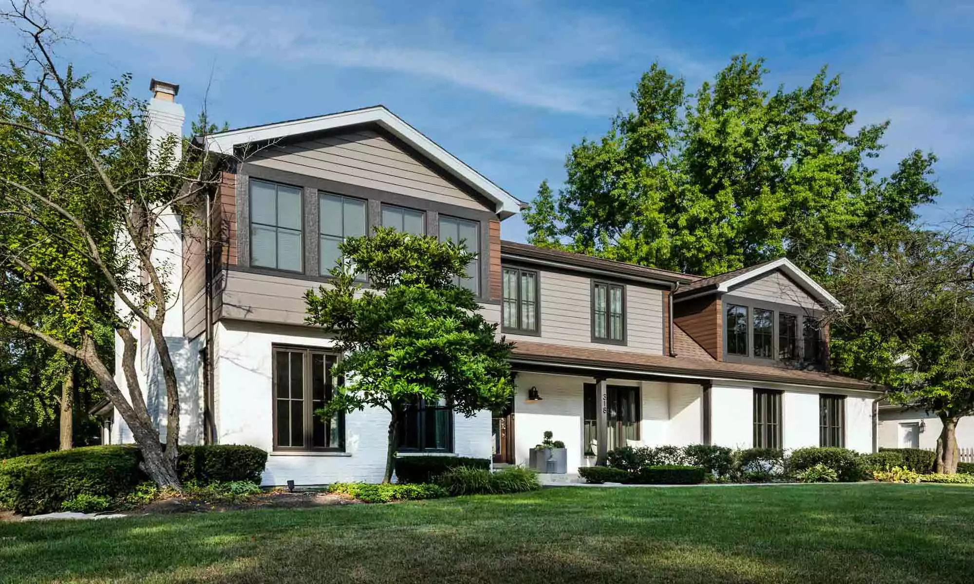 exterior view of primary suite addition with gray and wood siding