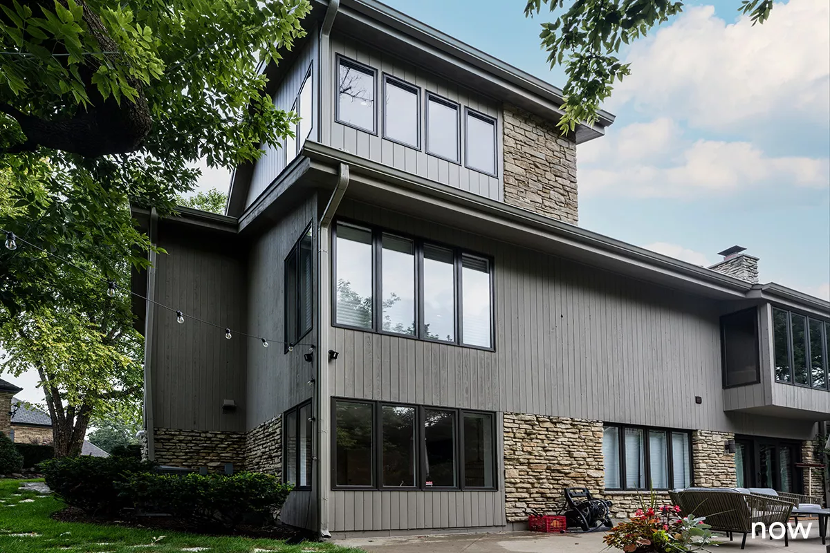 liv companies exterior view of home post renovation grey and stone siding