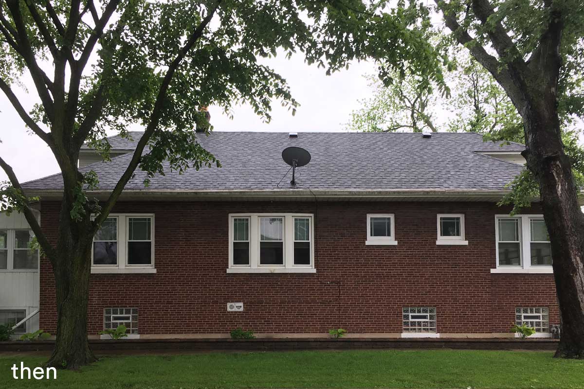 livco exterior home remodeling view of brick home backyard two trees white lined windows