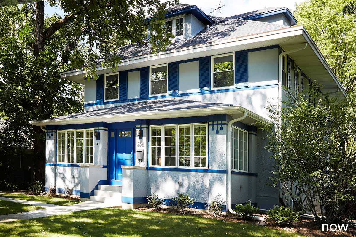 liv companies exterior view of grey white and blue home remodel with blue door