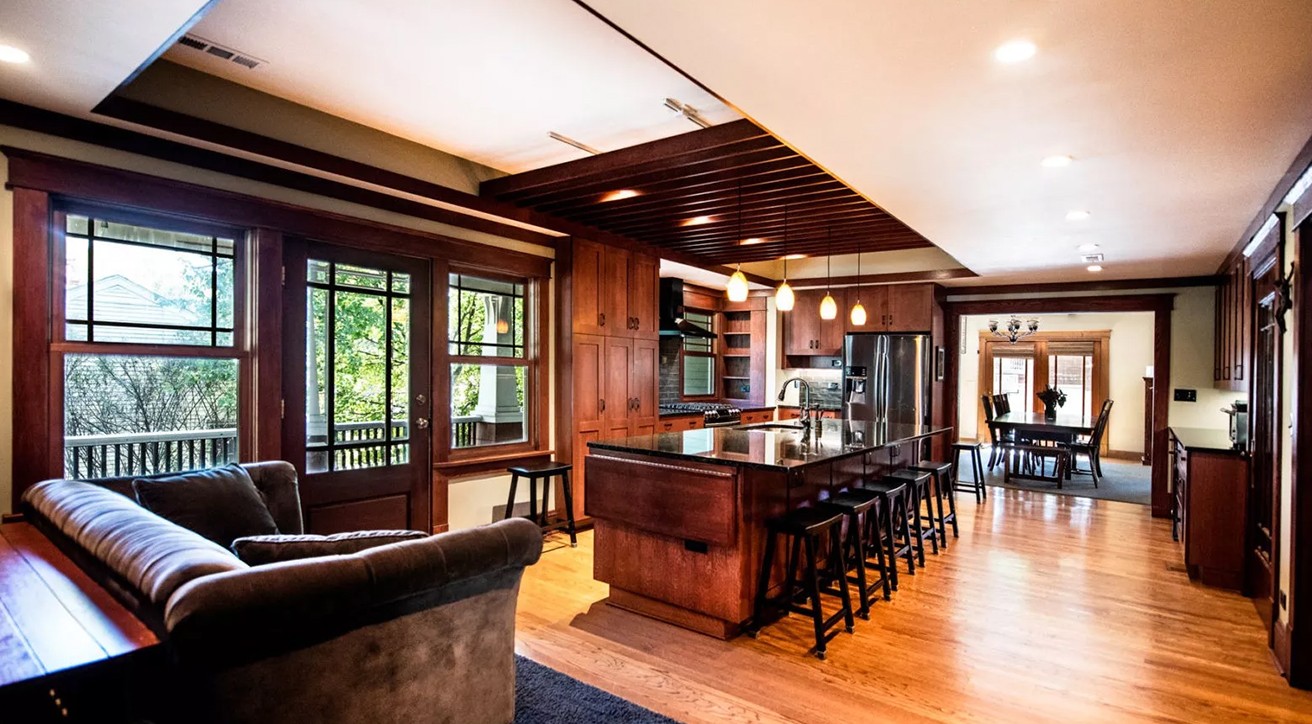 dark kitchen renovation exposed ceiling beams large black island separate dining room