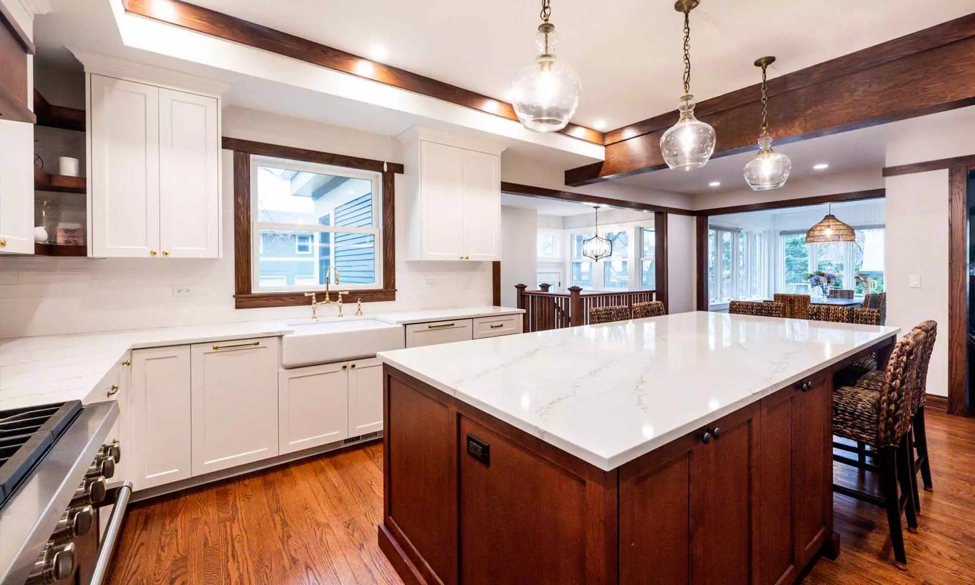 interior view of white kitchen cabinets and quartz island countertop