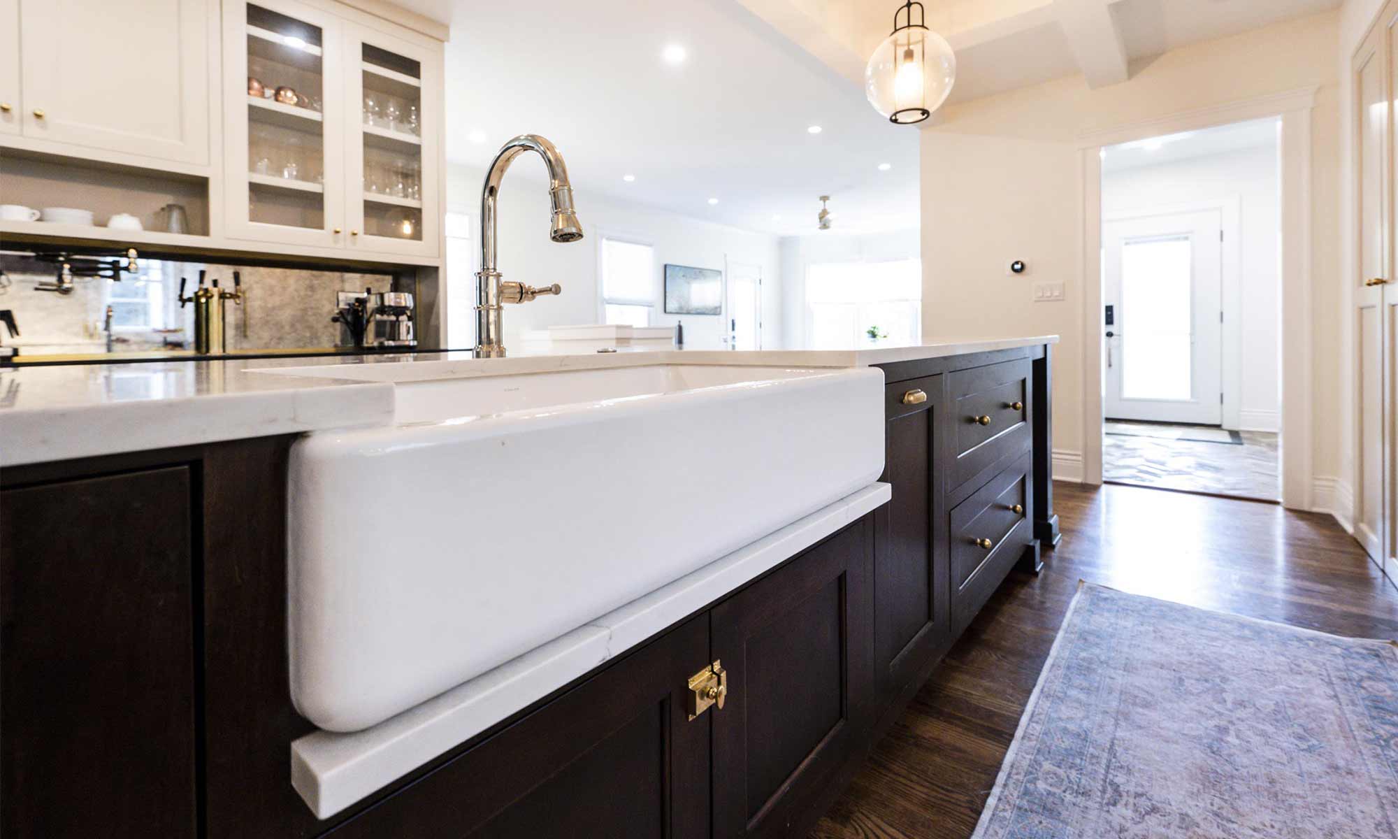 apron front sink with marble ledge and walnut cabinets in luxury kitchen remodel