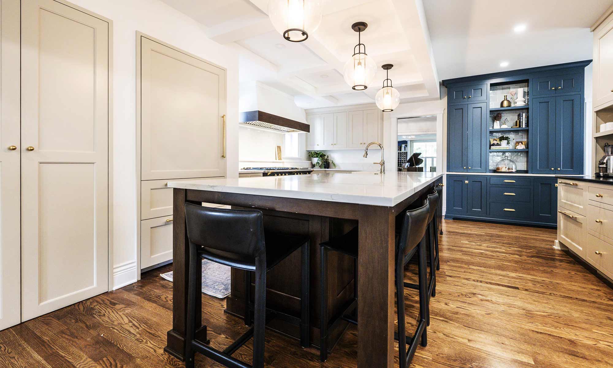 luxury kitchen remodel with walnut island, blue pantry cabinets and beverage bar
