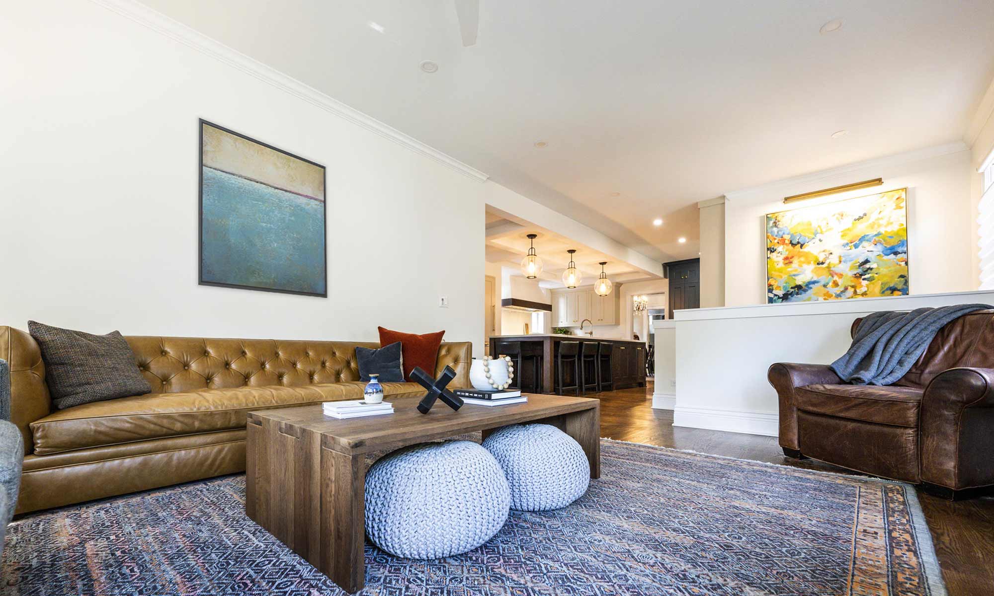 view of family room remodel with brown leather couch and lounge chair and artwork on the walls