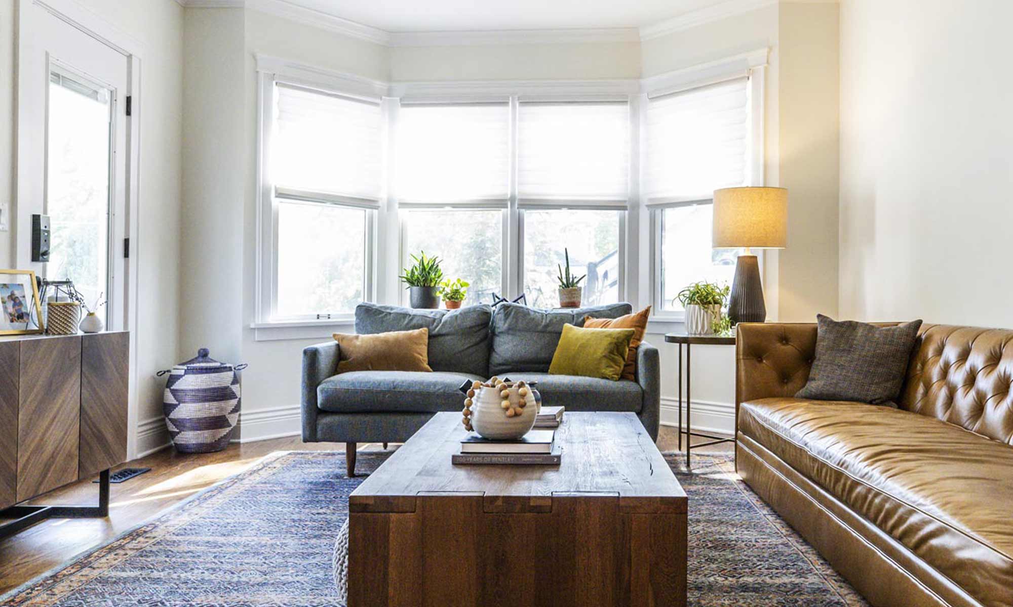 view of family room remodel with brown leather couch and artwork on the walls