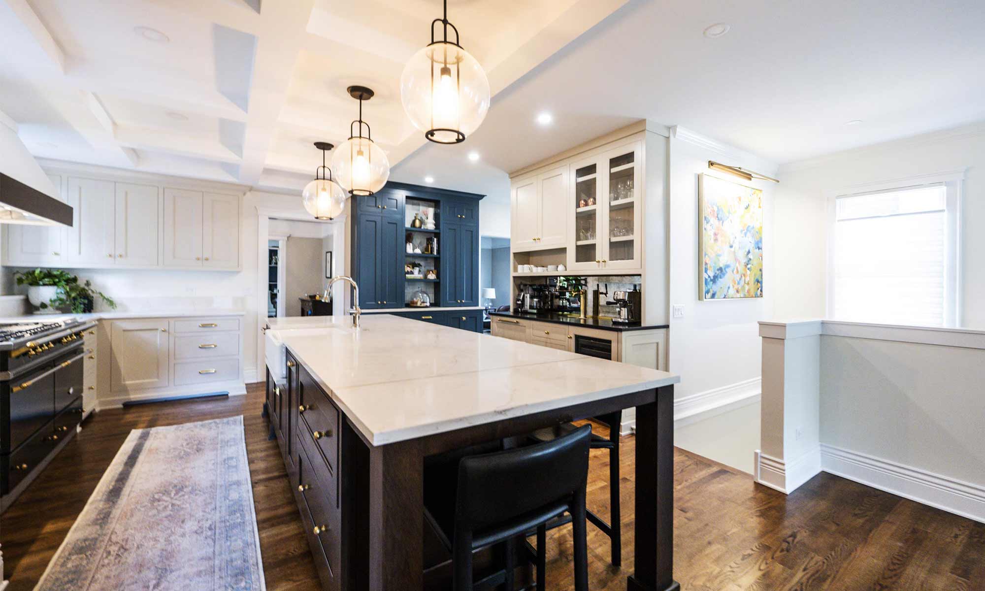 luxury kitchen remodel with blue pantry cabinets and beverage bar