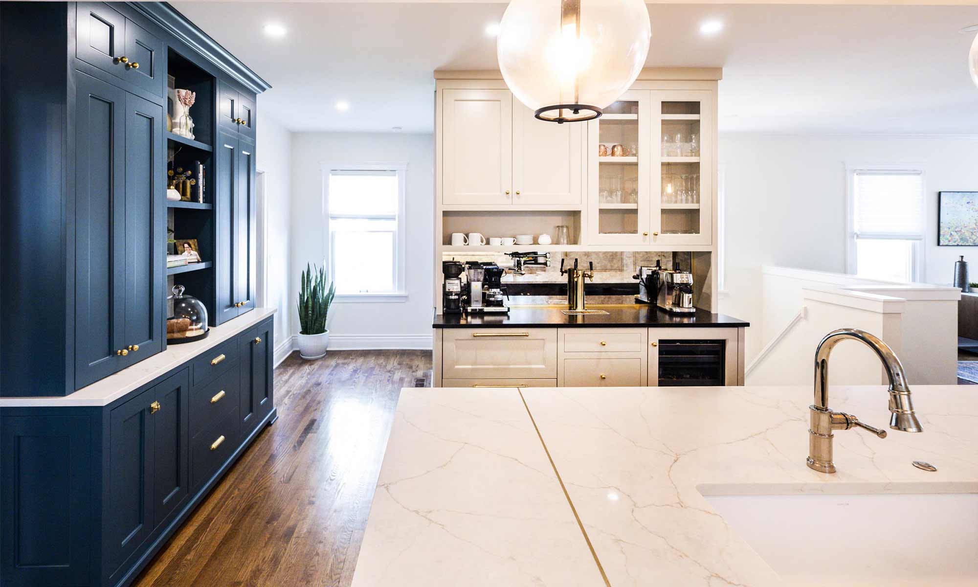 luxury kitchen remodel with blue pantry cabinets and beverage bar