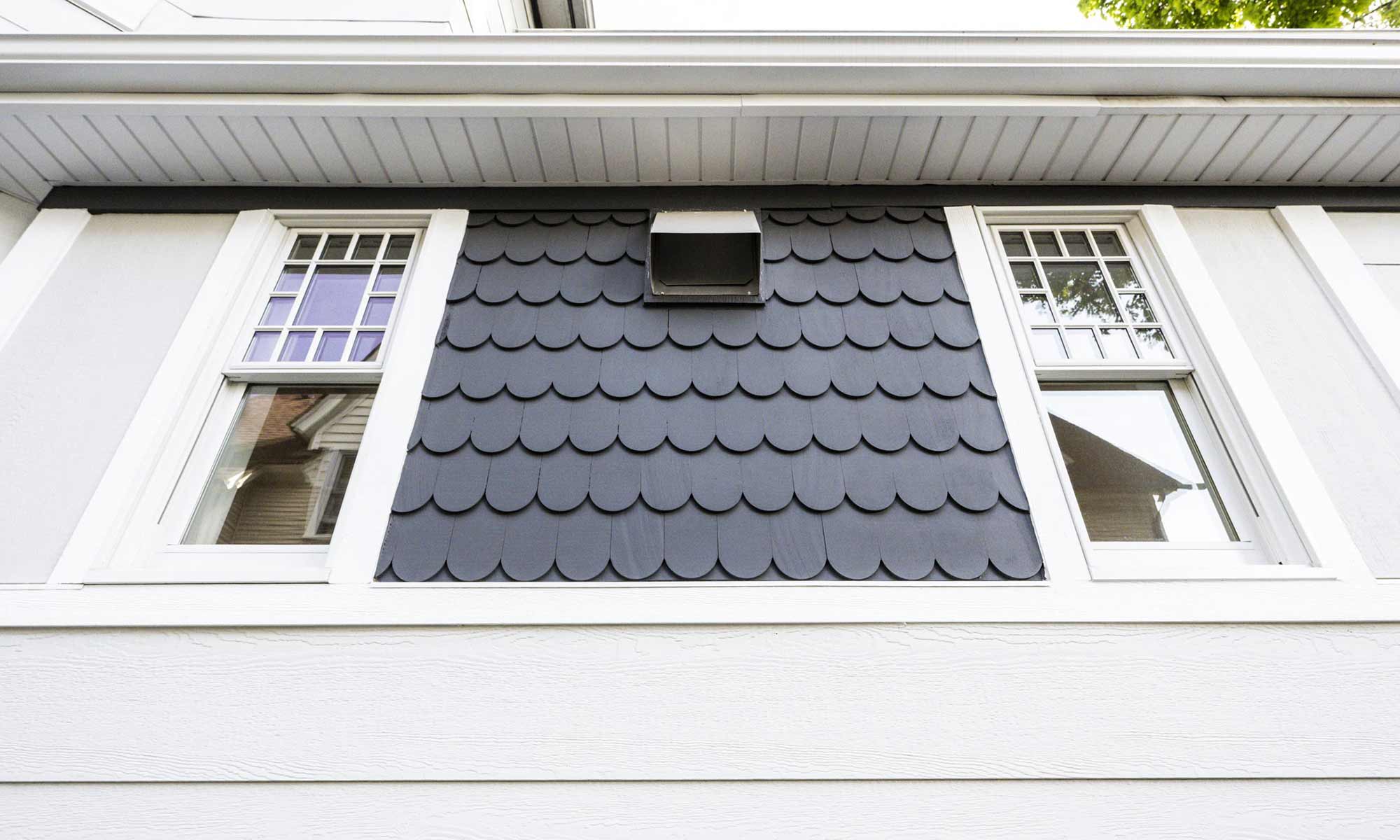 scalloped shake siding with Victorian windows