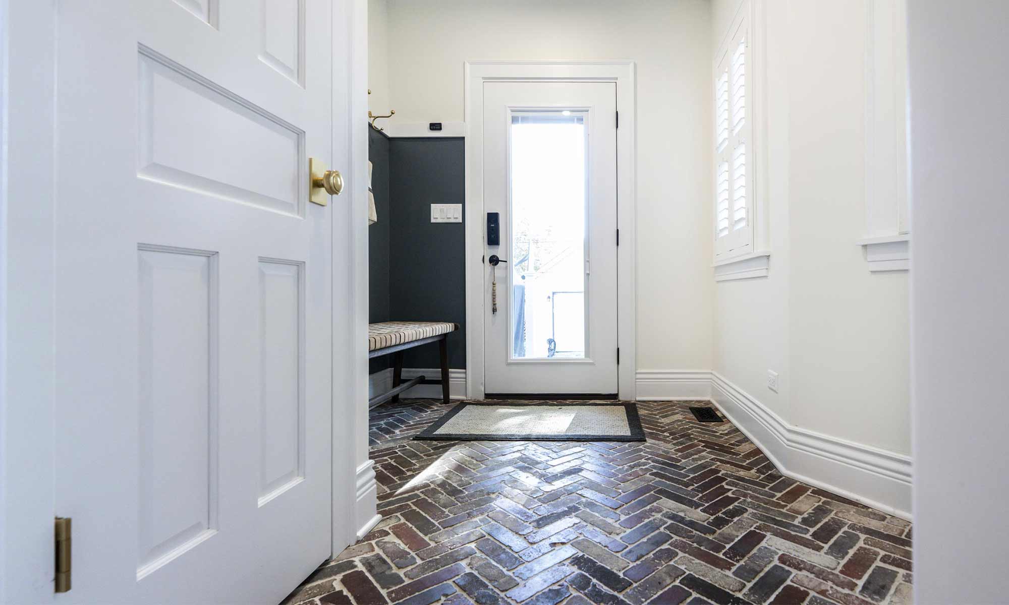 mudroom remodel with brick herringbone pattern floor tile