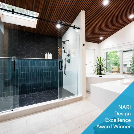 modern luxury bathroom remodel with blue tile in oversized shower and wood ceiling showing award winning badge