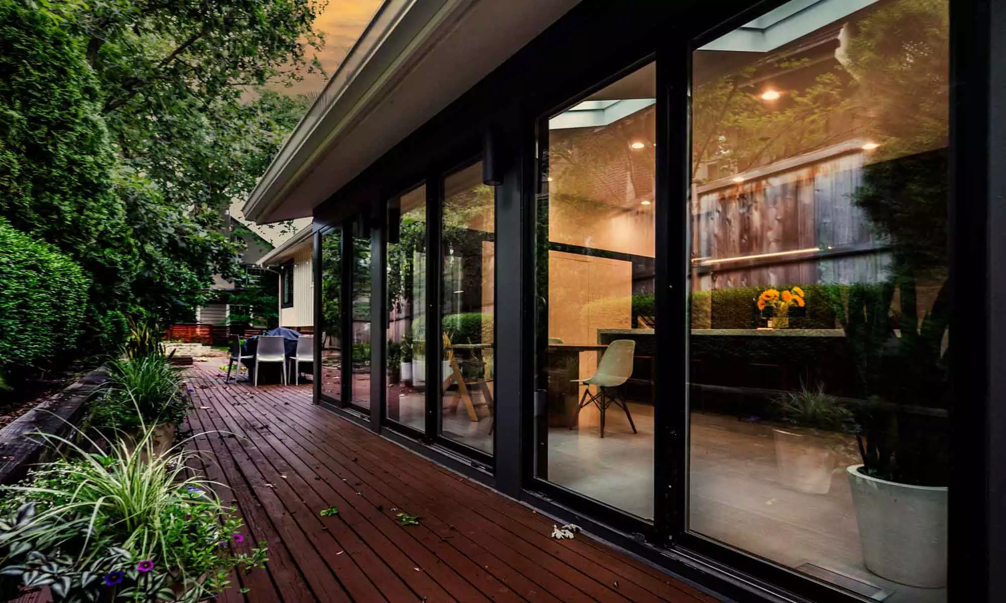 modern exterior remodel with black sliding doors to back deck