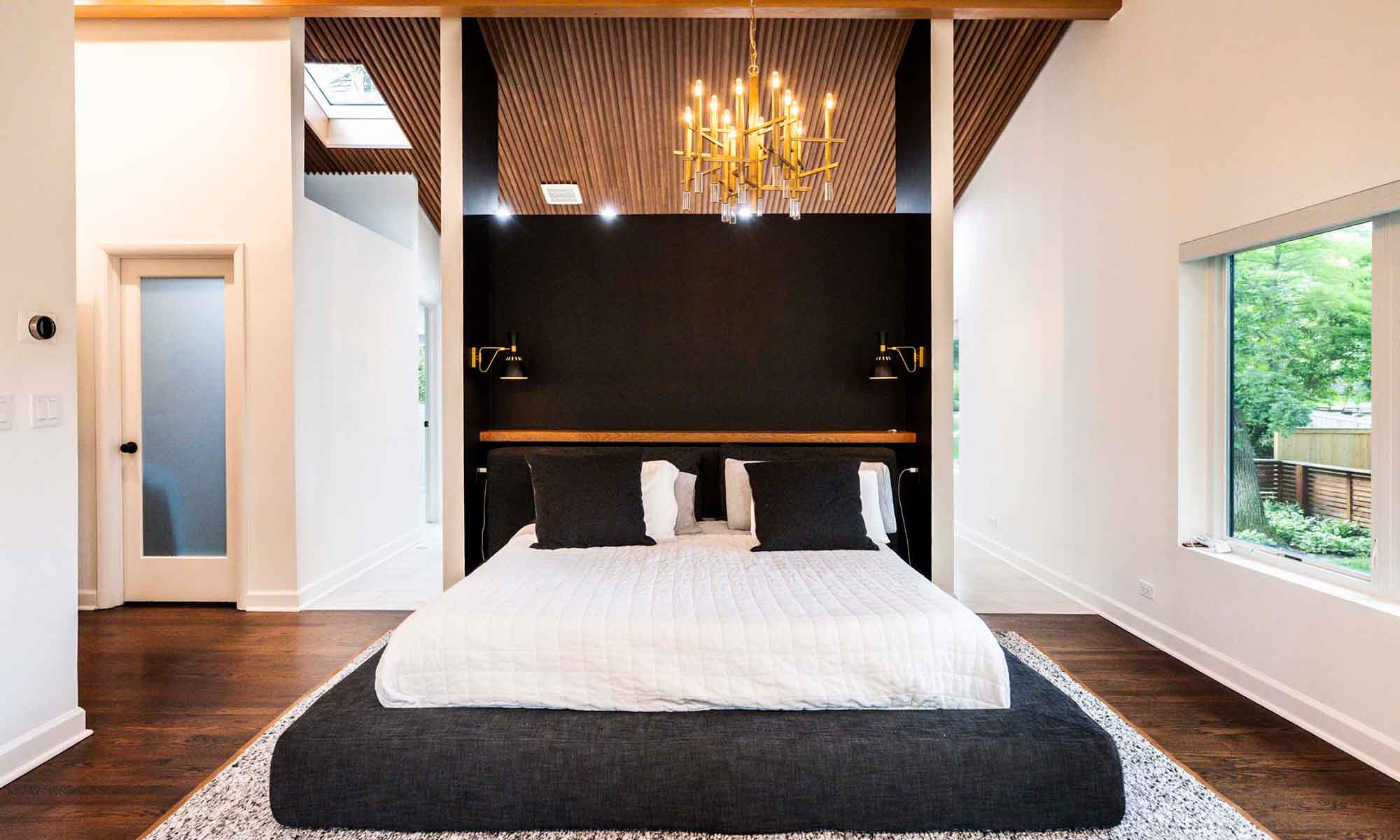 Wood ceiling behind primary suite bed wall in luxury modern remodel in hinsdale by livco
