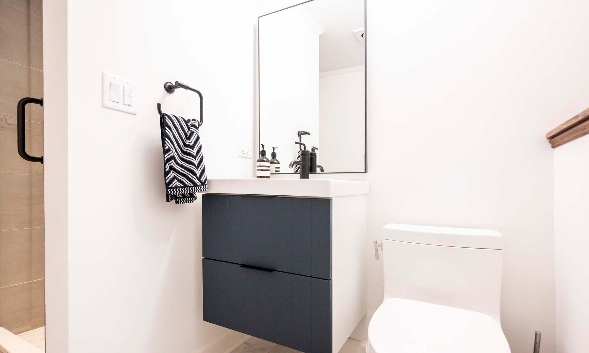 modern bathroom remodel with blue vanity