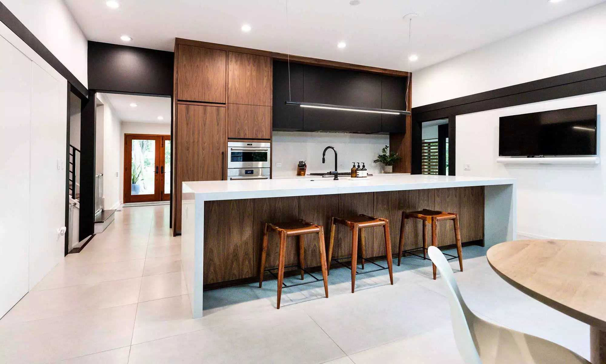 modern kitchen remodel by LivCo with vaulted ceiling and walnut cabinets in Hinsdale, illinois