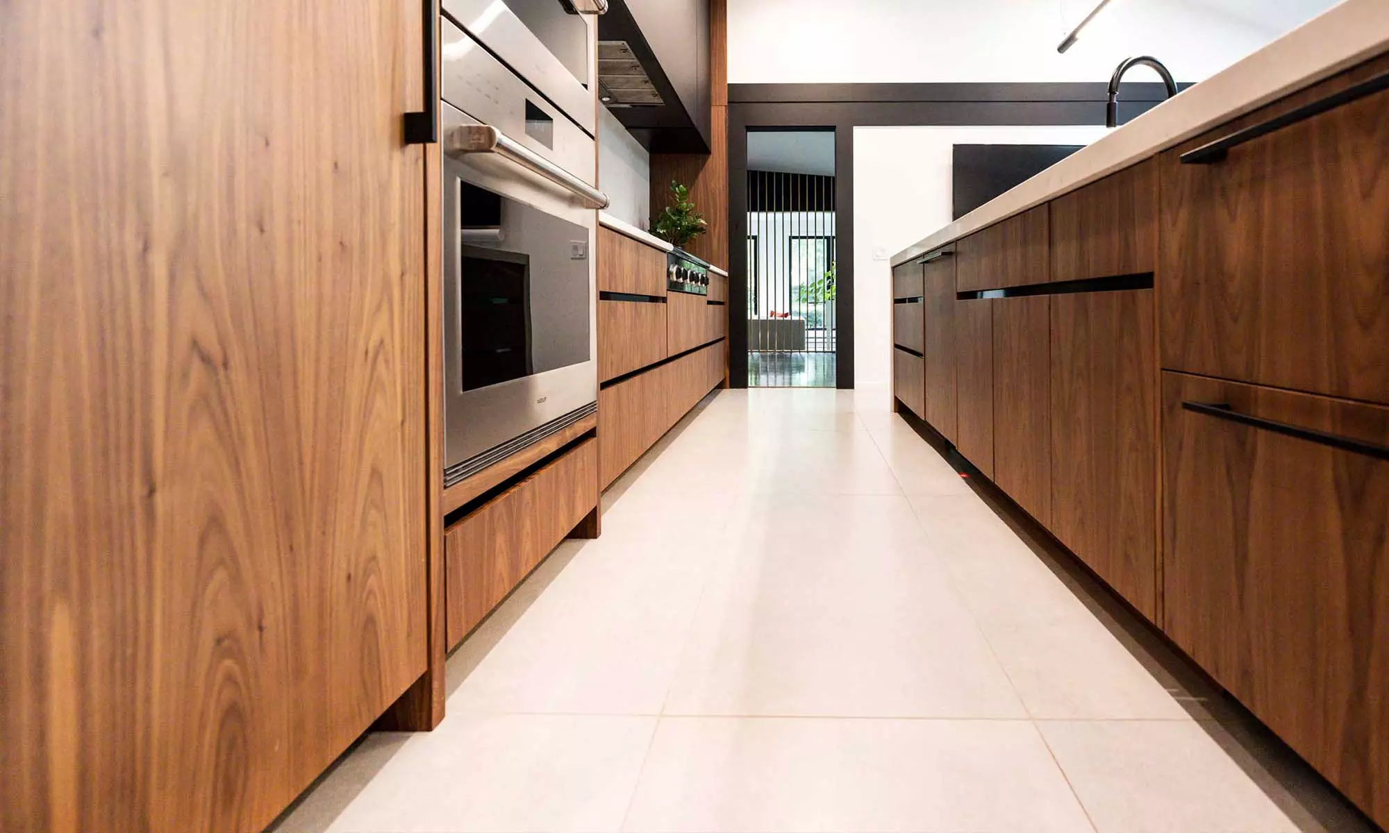 modern kitchen remodel by LivCo with vaulted ceiling and walnut cabinets in Hinsdale, illinois