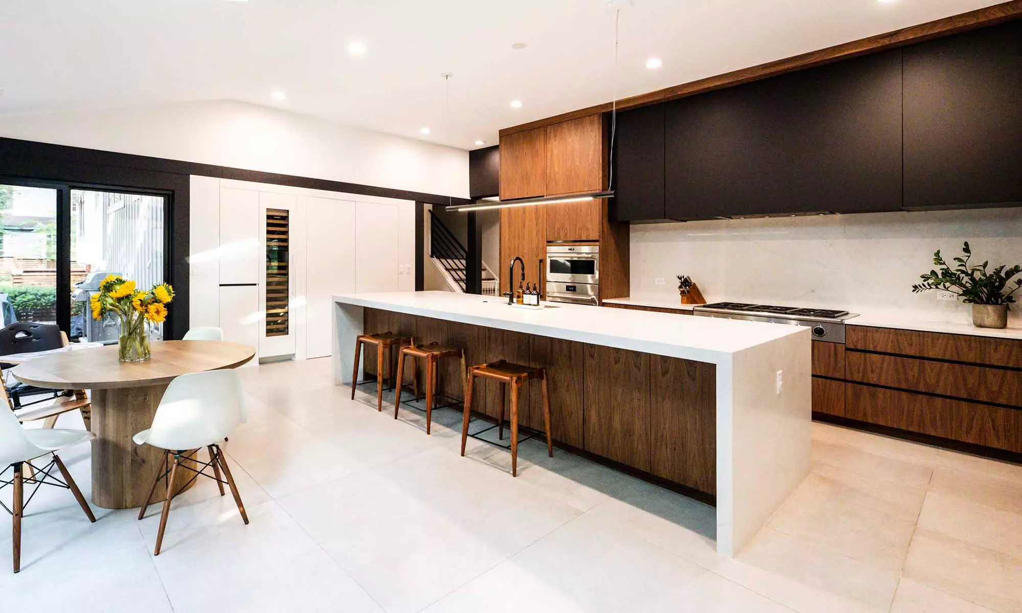 modern kitchen remodel by LivCo with vaulted ceiling and walnut cabinets in Hinsdale, illinois